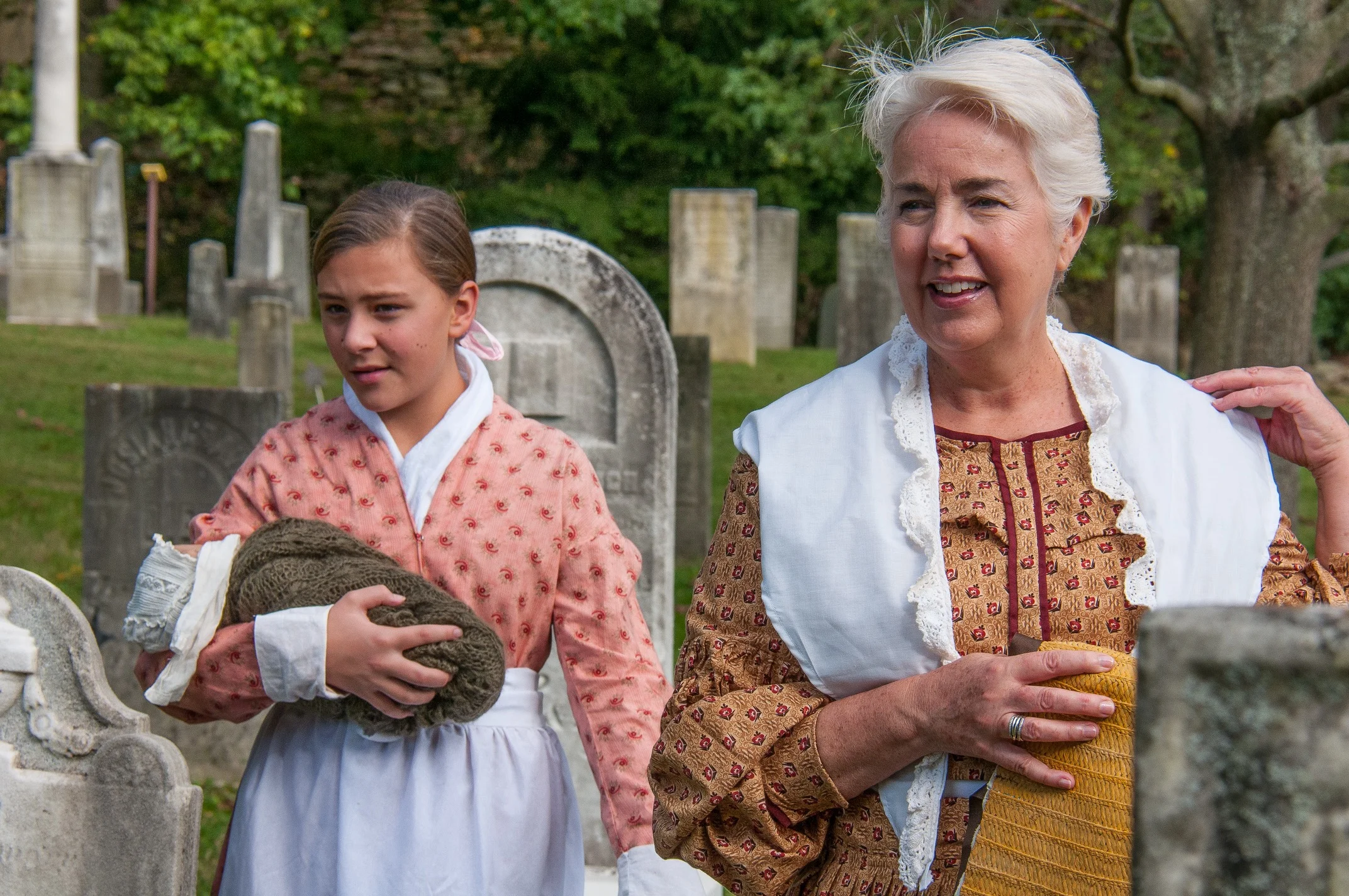 Sally Leithauser as Mary Root (holding her infant sister, Dameris) and Deb Eddy as Mary Barret Root.