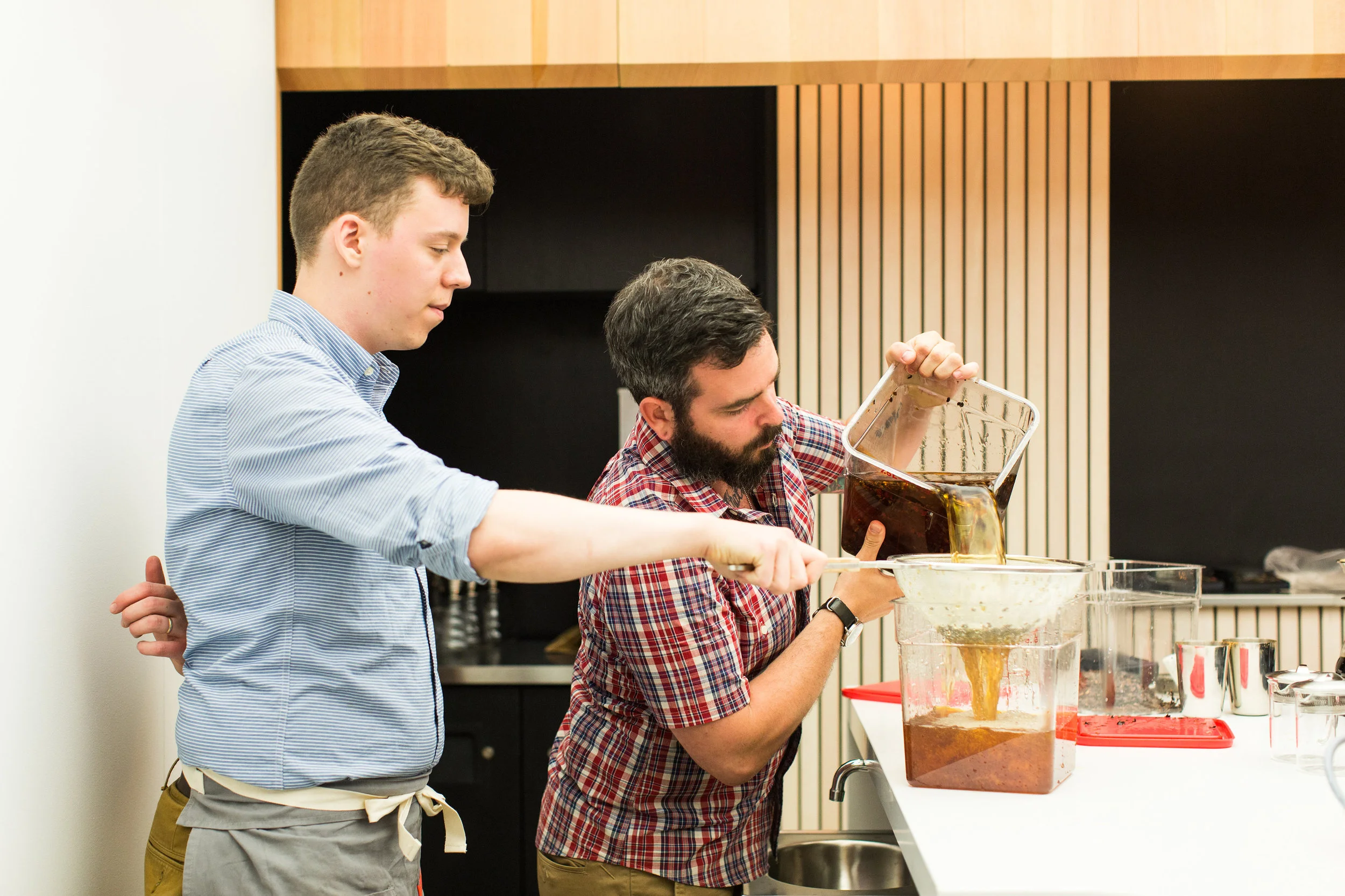Collin Moody and Ryan Burk filter the cascara cider