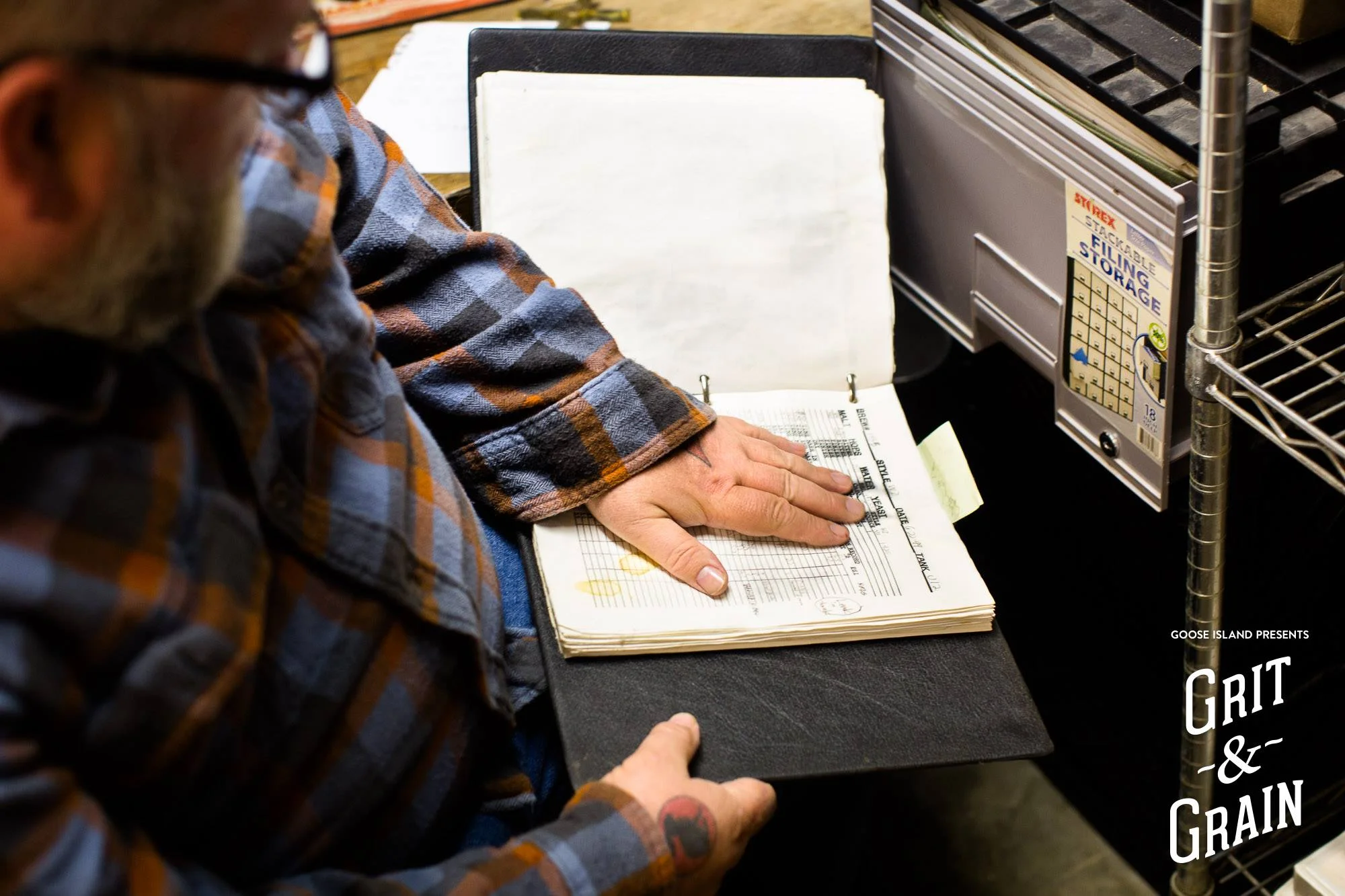 Greg Hall looking through the old Clybourn log books for the first BCS brew. 