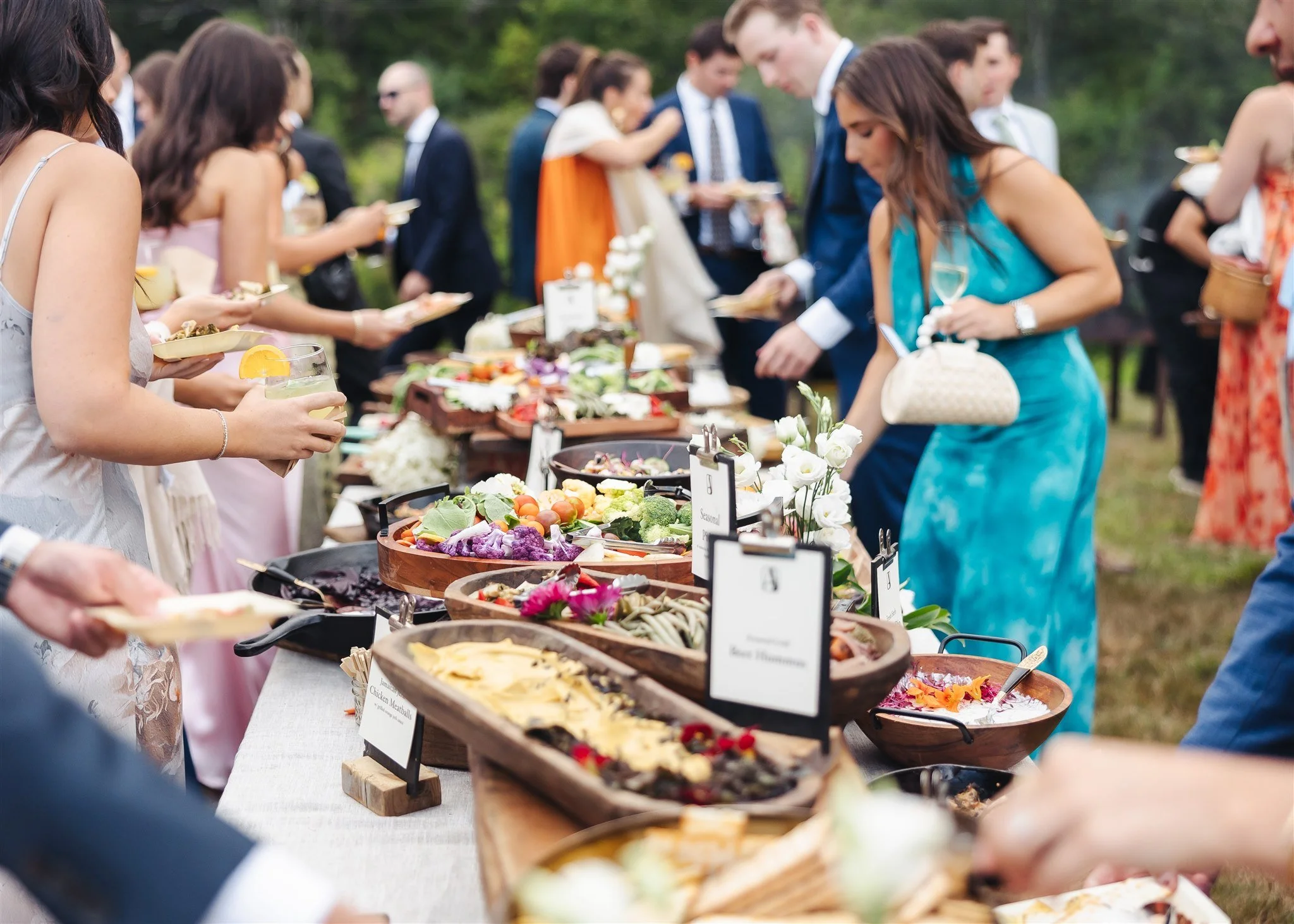 Guests walking along food table at wedding in Maine with Applecroft Catering