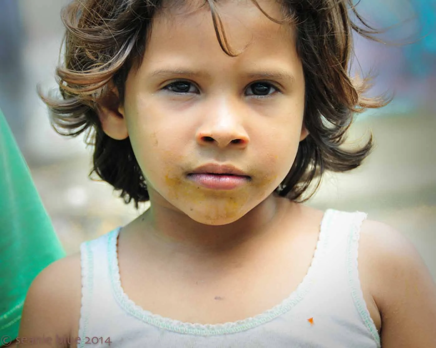 A girl, in the slum, posing for cash: a picture of hope before it is extinguished.