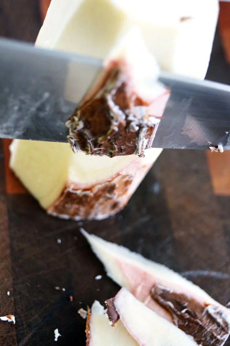 It is important to peel the purple/pink layer just beneath the skin to avoid cyanide intoxication. 