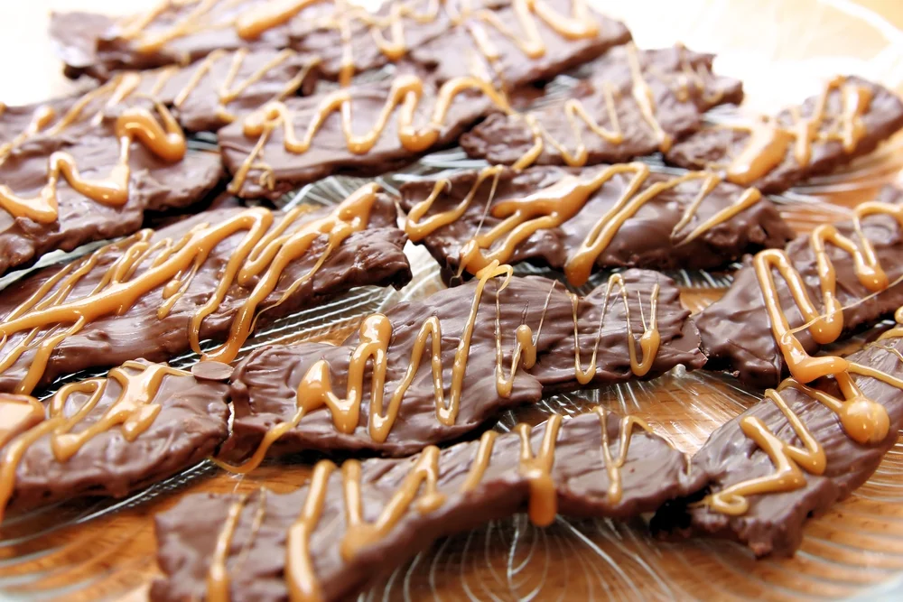 Chocolate covered bacon with caramel drizzle