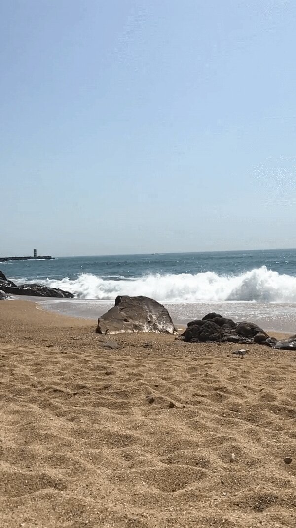 Waves rolling in very slowly on Praia dos Ingleses in Foz, Porto