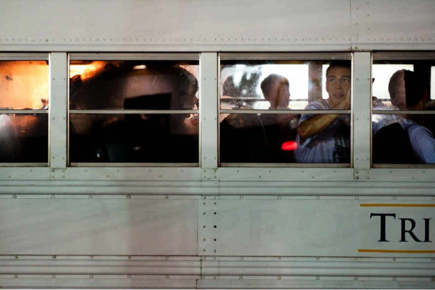 Hayes Thielman, a junior, looks back out the window of the Trinity bus at 10:30 pm. The team had just enjoyed a quick dinner together before making the 2 hour drive back to Durham from Greenville. Despite their loss, Hansen French, Senior Captain, said that they will "sing, procrastinate homework, and gossip all the way home."