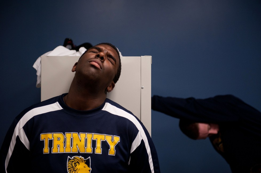 Maurice Troy, junior, winces as half-time as Coach Mike Huff tries to pump up the team. They had fallen behind Burlington Christian Academy by nearly 20 points and, according to Troy, had little hope of catching up.