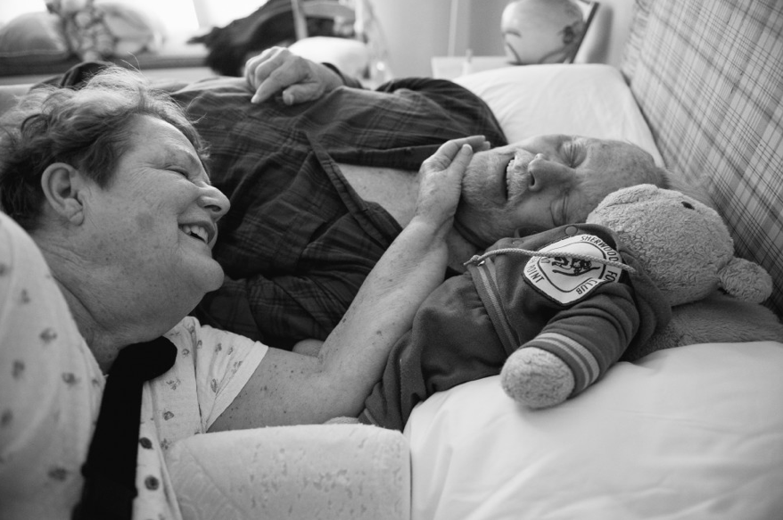  Roz and Lou Van Houten lay in bed before they must get up for another day filled with “acts of love”, as Roz calls them, when they each have to compensate for the other’s disabilities. 