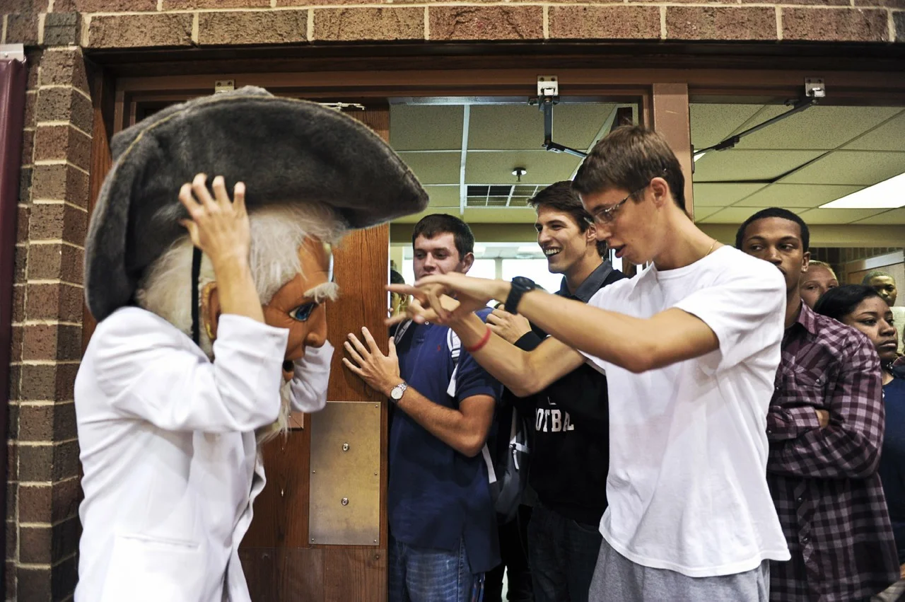 Alec Peters (right), Hunter Comer and Marshall Garret pump up their friend, Hank Daughtry, dressed as the Henderson County High School mascot the Colonel, before he runs across the court during the Homecoming Pep Rally.