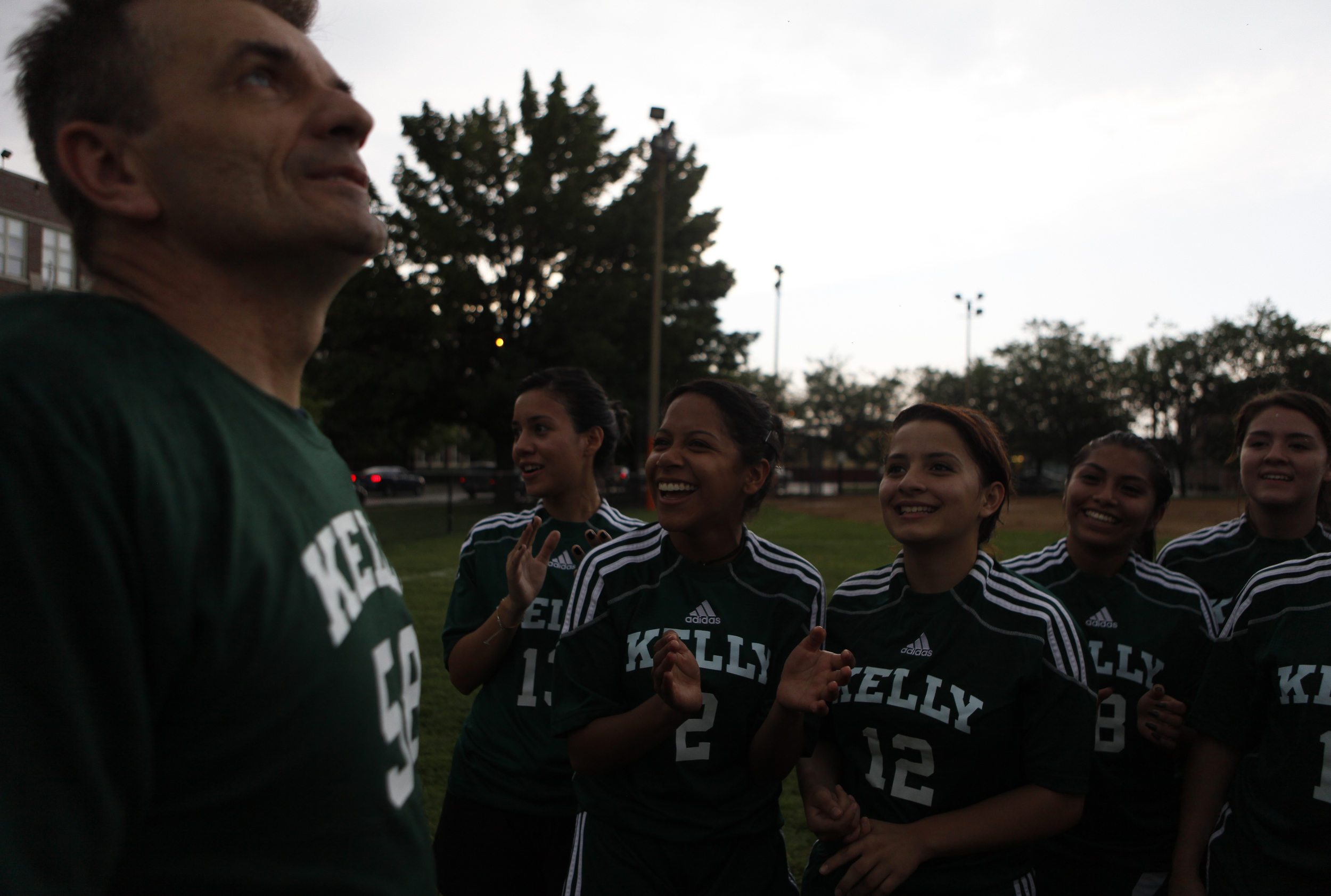  Head Coach Stan Mietus looks up at the stormy sky as the girls chant during practice in front of the Kelly High School in Chicago on Tuesday, June 11, 2013. &nbsp;They were counting the number of seconds after a thunder clap to see if there was goin