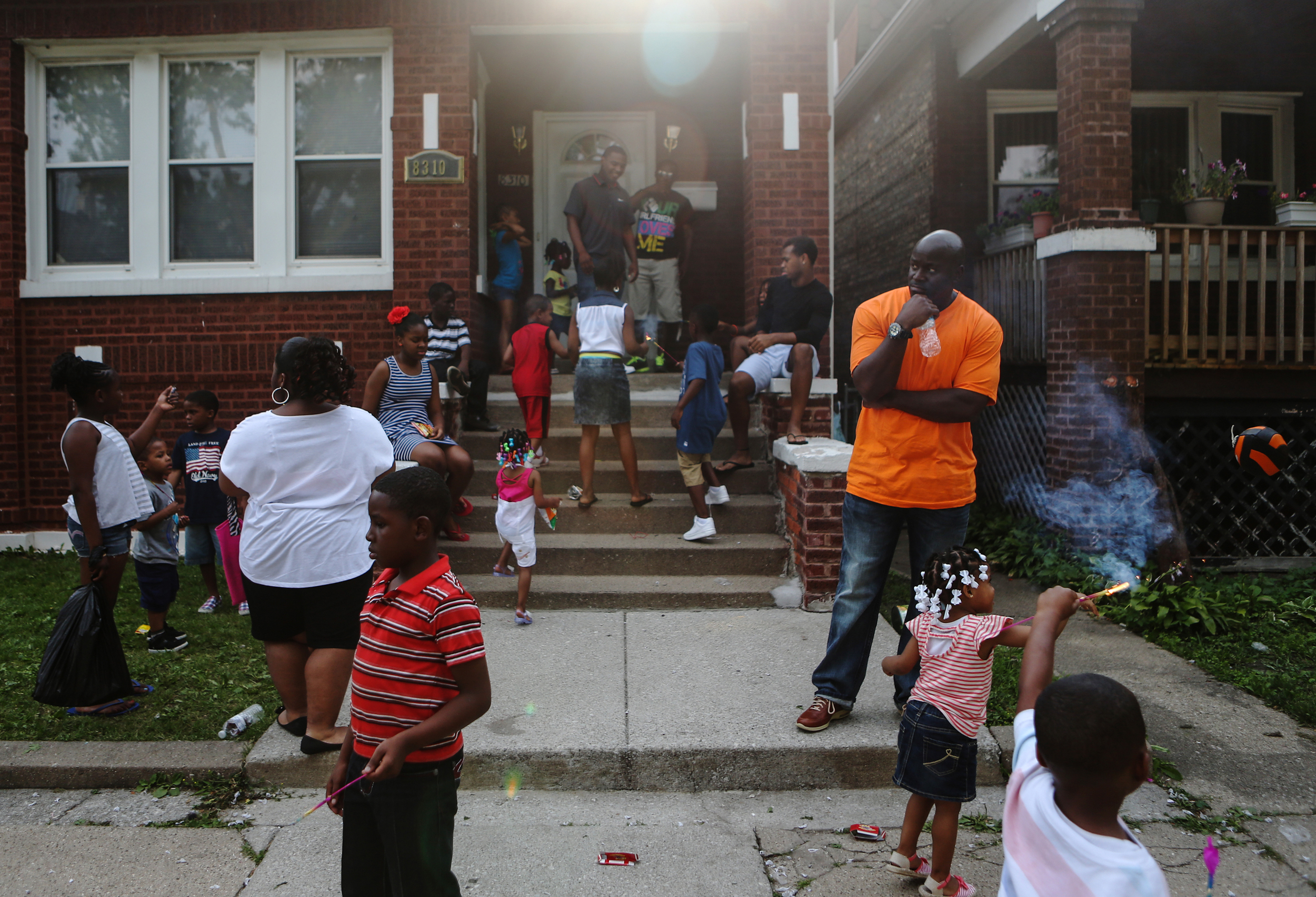  Daniel Taylor, center, watches his nieces and nephews play in front of his Aunt Marie's house on Thursday, July 4, 2013. &nbsp;Nearly all of his nieces and nephews were born during the twenty years he was incarcerated. &nbsp;The Fourth of July, his 