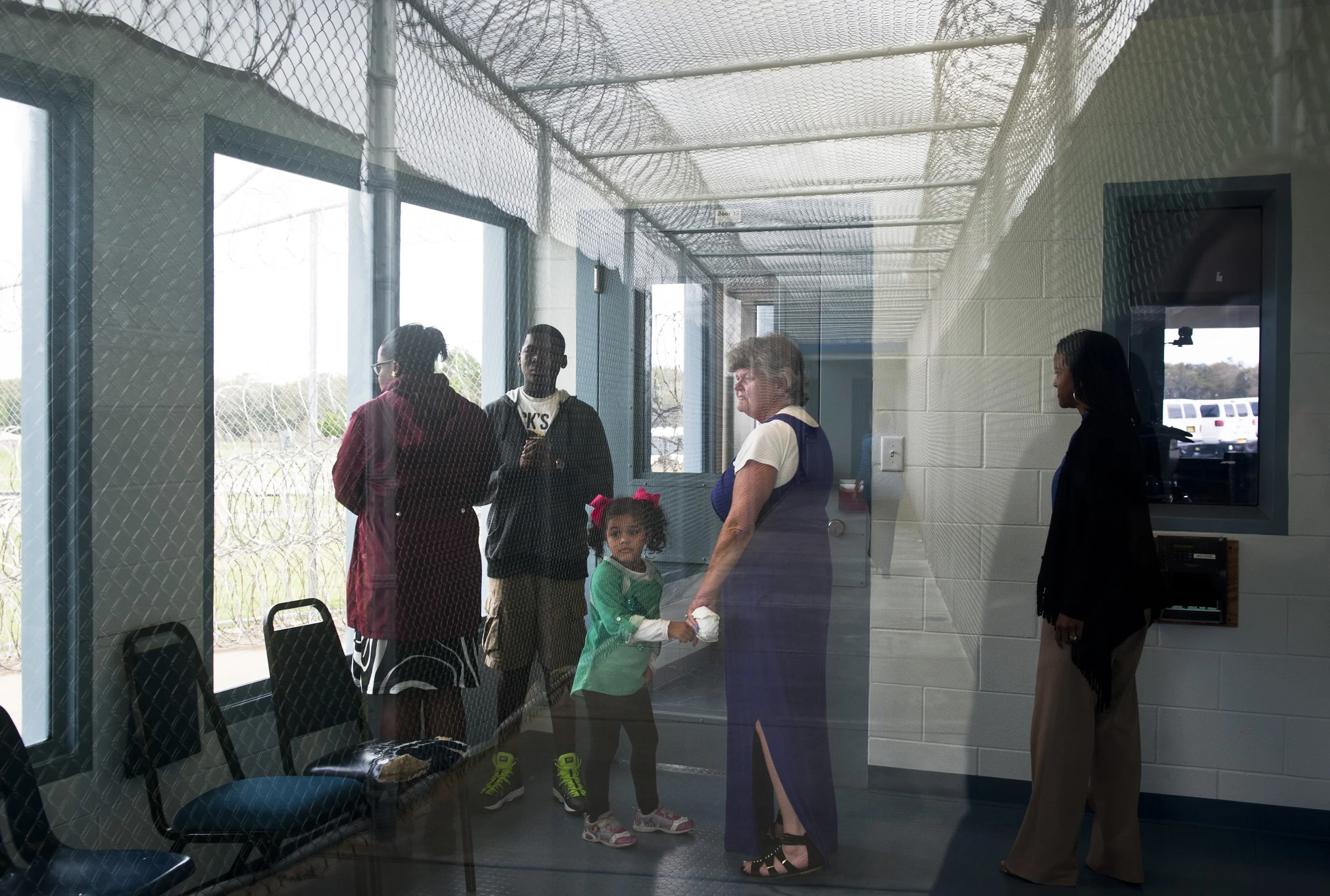  Mary holds Nevaeh's hand while they wait in a secure holding room at Lowell Annex prison in Ocala, Fla.&nbsp; Nichole and Nevaeh hardly know each other, since almost all of their interactions have been during prison visitation hours and through vide
