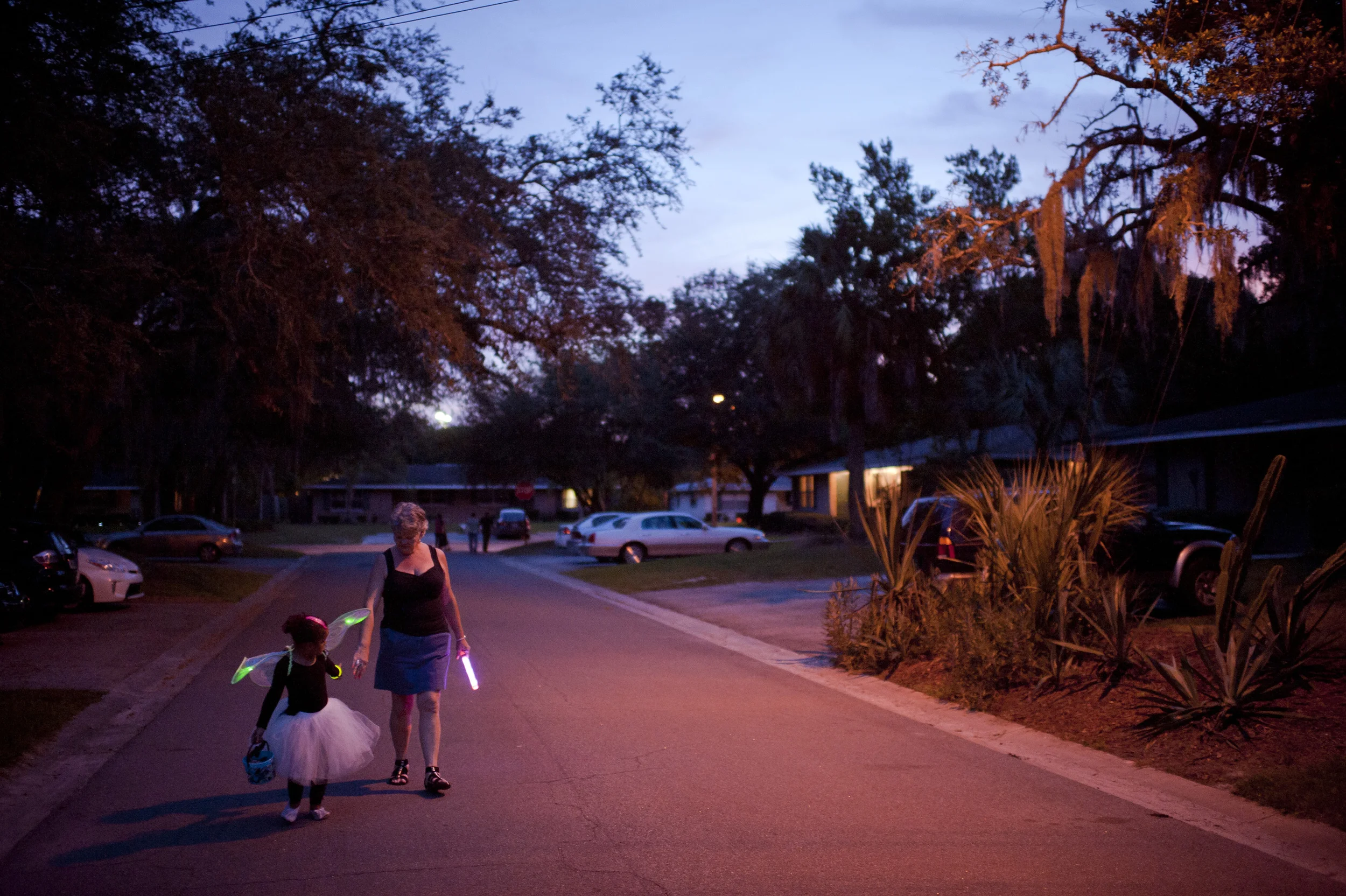  Mary trails after Nevaeh as Nevaeh runs from house to house trick-or-treating on Halloween.&nbsp; They only visited one section of their neighborhood closest to their home--about ten buildings--because Mary was too exhausted to walk any farther. &nb
