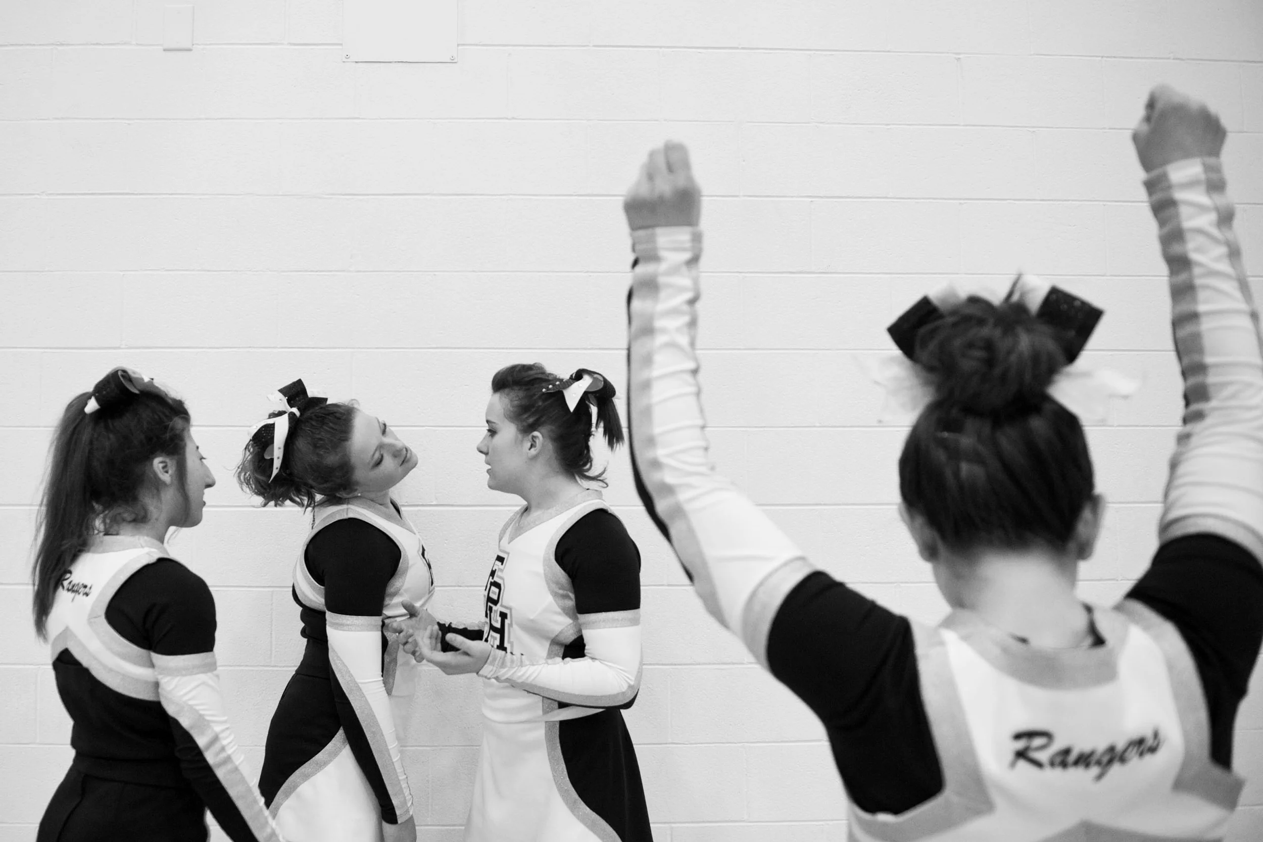 Morgan Uebelhor, left, watched as Shelby Olinger made a frustrated face at Tabbi Bolt while Payton Prechtel practiced before the game on Thursday in Lincoln City. Heritage Hills defeated Forest Park 68-59 in overtime. All are Forest Park varsity cheerleaders. 
