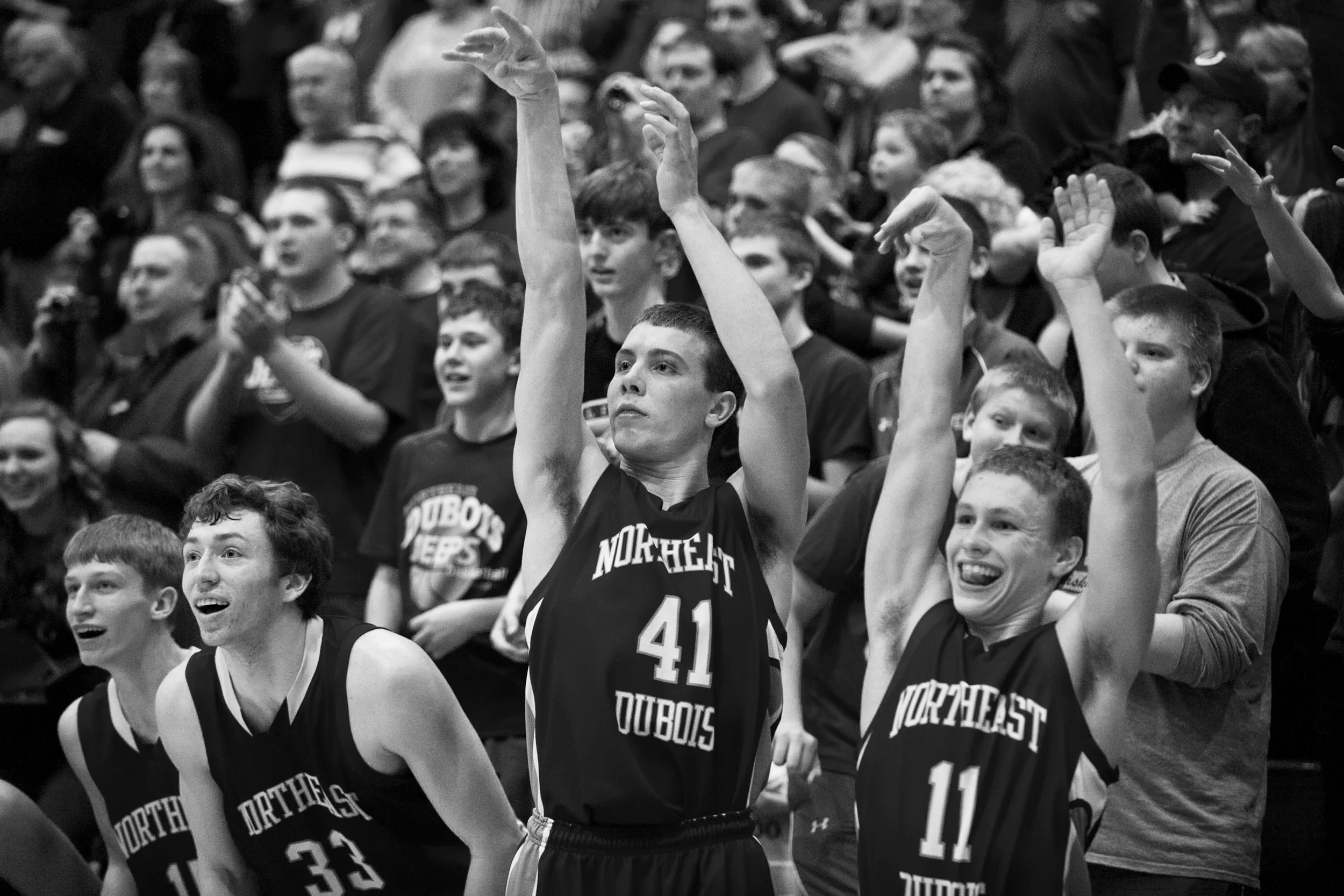 The Jeeps' Tyler Haas, left, Jacob Gress and Tristan Linne made a shooting motion from the bench just seconds before winning the IHSAA Class 1A sectional tournament against Tecumseh in Lynnville on Saturday. Northeast Dubois won 55-45.