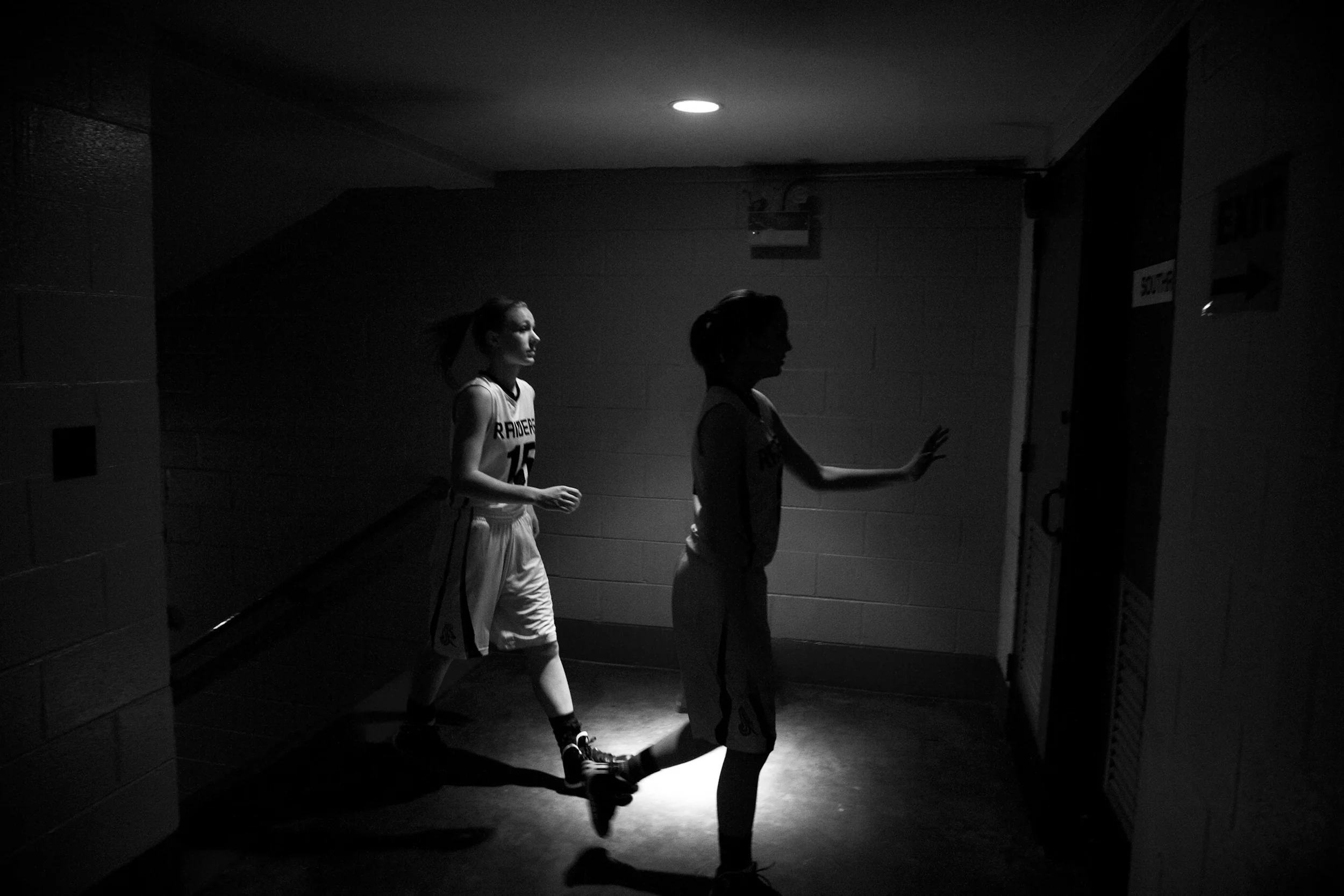 Southridge's Taylor Neukam, left, walked into the locker room with her team after the game Thursday. Southridge beat South Spencer 51-20 at Memorial Gym in Huntingburg. 