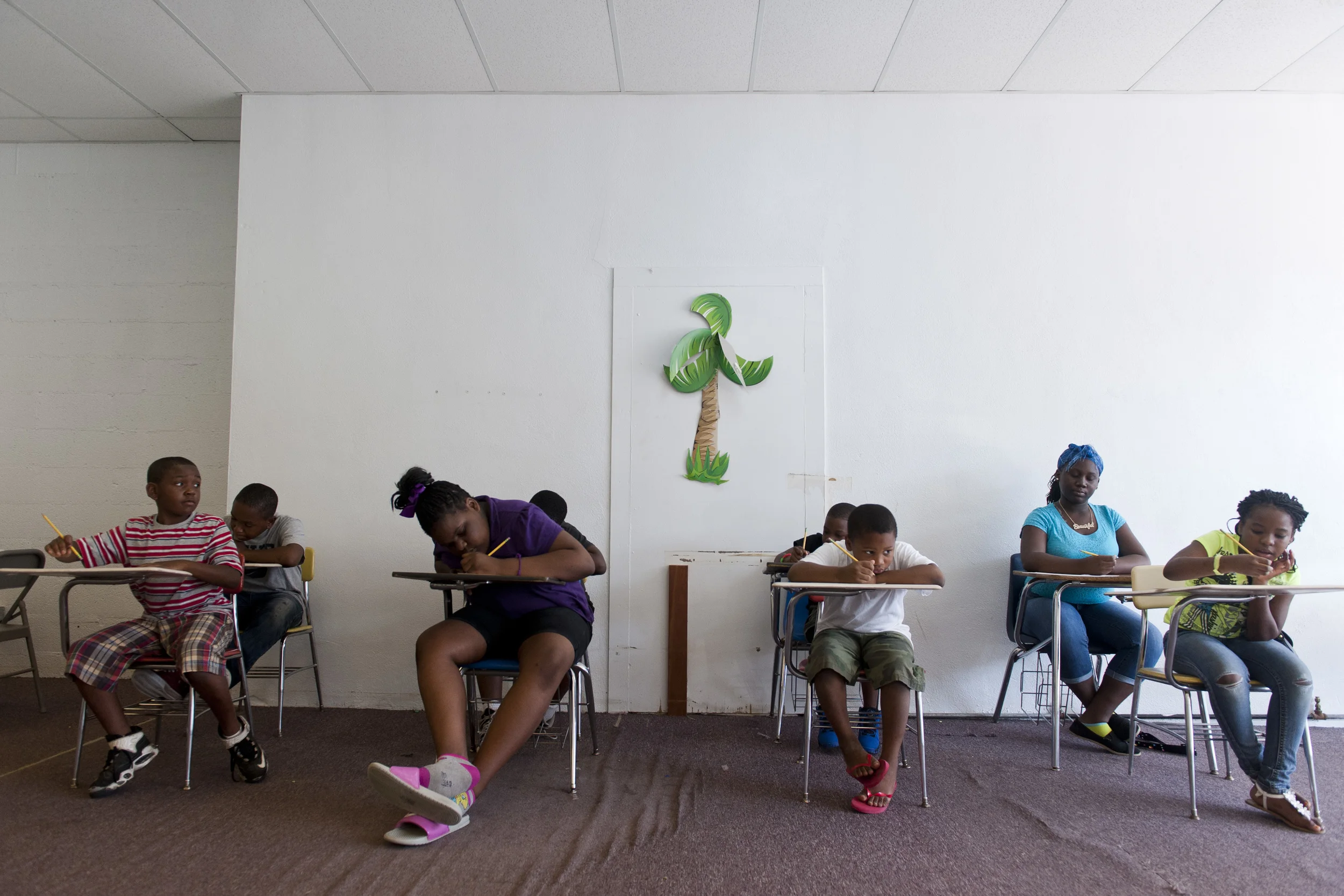  Students write an essay about what they enjoy and what they would change about the summer program at Vision Education Center in Dillon S.C. on Tuesday, July 29, 2014. &nbsp; &nbsp;"People in this community want change in their children's educations 