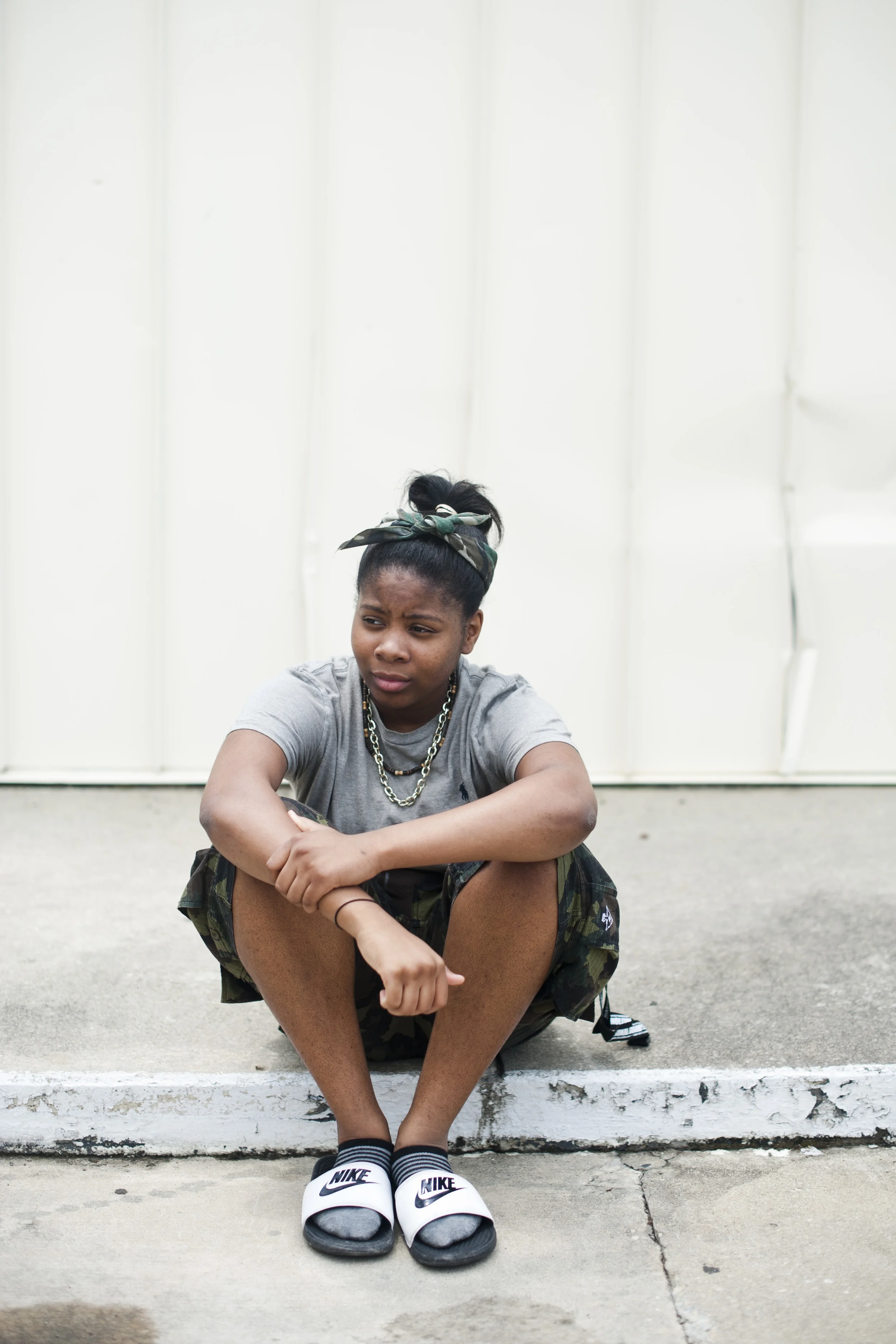 De'Juanna Bethea, 15, sits for a portrait outside of Lil Bill's convenience store in Dillon, S.C. on Sunday, July 20, 2014. She is originally from Dillon, but now goes to Lumberton High School, which is just north of the state line into North Carolina, because she said that the education is much better there. Photographed for Al Jazeera America. 