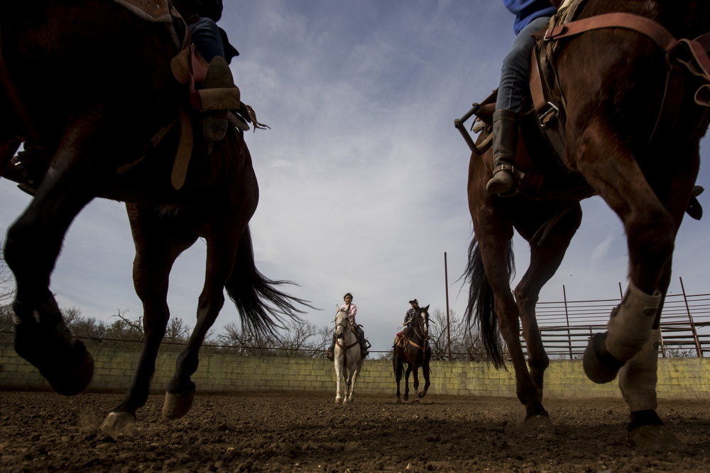 Miriam Alejandra Montecillos and Emely Ayala canter in formation during practice at La Herradura Ranch in San Antonio, Texas on March 7, 2015. "There is nothing else like escaramuza, so we know it is not forever, but we will do it as long as we can," Leticia Ozuna, mother of Montecillos and Ayala's teammate Caterina Ozuna, said. 