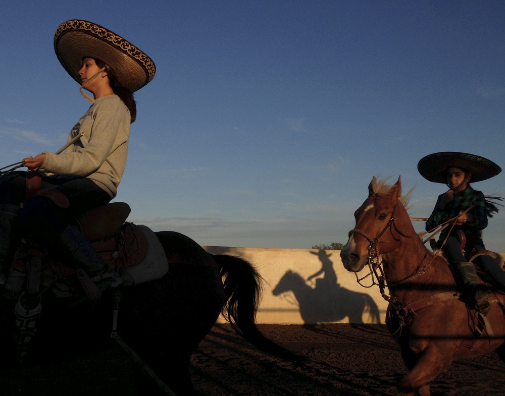Caterina Ozuna and Miriam Alejandra Montecillos warm up before practicing their routine for Pre-Estatal at El Rancho Unico in Atascosa, Texas on March 26, 2015. "You feel the nerves the moment you go in," Ozuna said.