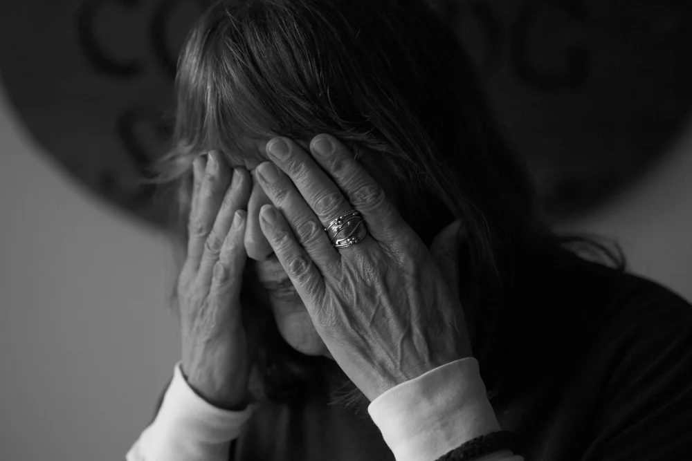 Marti Sousanis puts her hands over her face as she tells a story in her home in San Francisco, Calif. on June 2, 2015. Eight years ago, Sousanis was evicted through the Ellis Act, which is a state law giving landlords the right to evict all of the tenants in a building in order to shut down their business, often with the intention of selling the building for a profit. After getting pushed out of the Mission neighborhood years ago, she now faces eviction for a second time. Her rent has increased by $650 since January. Before the increase, Sousanis, who has lived in the city for over fifty years, said she was already living solely on her social security checks. "Since the increase, I have maxed out two credit cards and am working on a third just paying for food and doctors," she said. "I don't qualify for food stamps, because my rent is too high. The irony! ...I had to go to a charity to ask for money for the first time in my life, just so I could avoid eviction for a little while longer. I am a part of what has made this city the creative, tolerant city that it is. You are taking me away from my home, my friends, my business, my everything." 