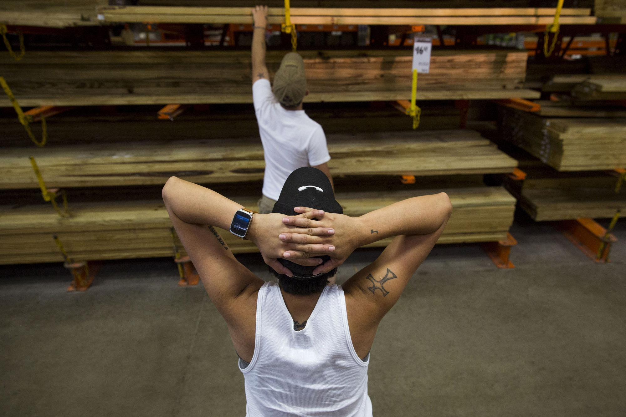 Glenda Bamberger puts her hands on her head as she waits for her husband Jarrell Bamberger to pick out wood at Home Depot in Bulverde, Texas for the construction of their new home on July 11, 2015. Their previous home was destroyed during the Blanco River flooding in May. During the more than 13 hours that they worked on their new home that day, they visited Home Depot twice. 