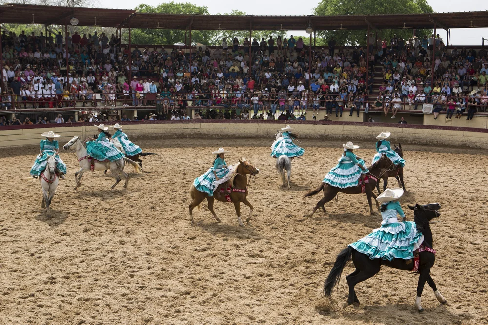 Escaramuza Las Potrancas does a "giro", or a 360 degree spin, during their performance in the "A Day in Old Mexico" Charreada at the San Antonio Charros Association in San Antonio, Texas on April 26, 2015. 