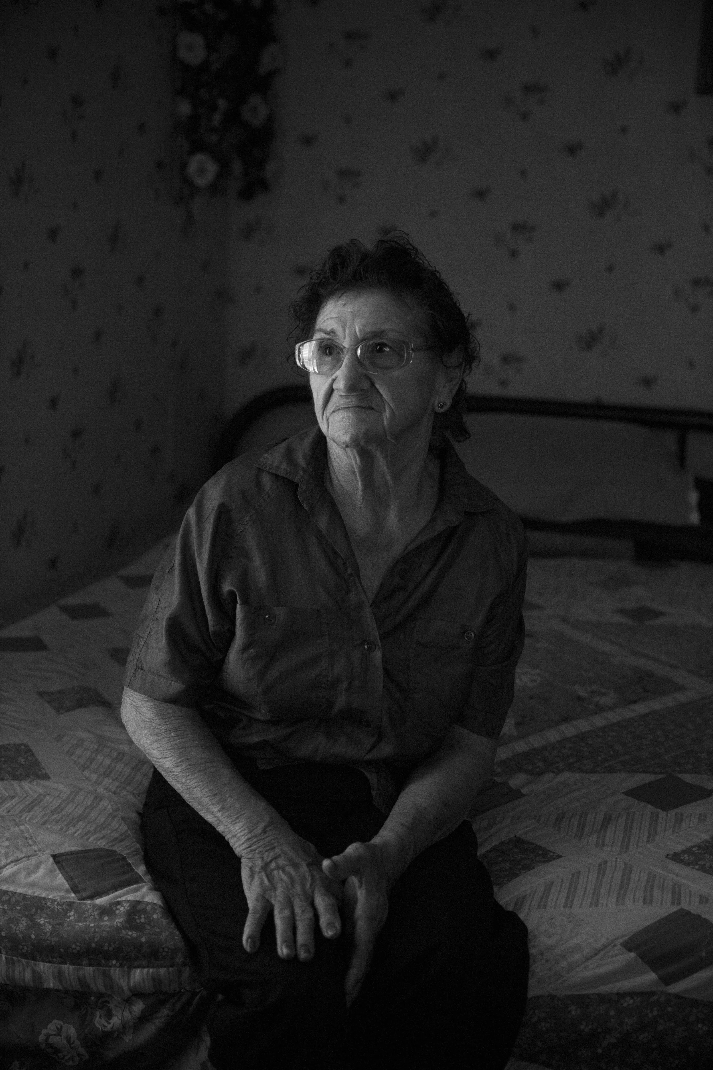 Trine Tellez, who has two sons who worked in the oil field, sits for a portrait in her bedroom in Cotulla, Texas on June 19, 2015. She said she worried when they would go to work. "Who would take care of me if something happened to you?" she would ask. One of her sons, Ysmael "Smiley" Tellez who has since left the oil field, lives with her now and helps to take care of her.