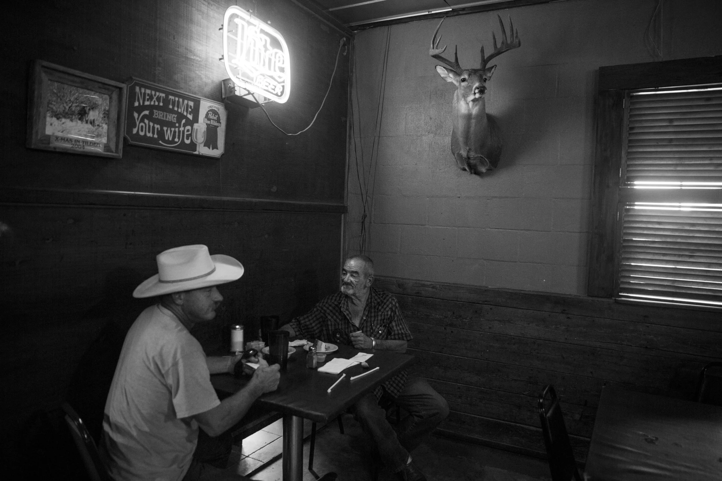 Ronnie Moore and Billy Davis eat lunch at JJ's Country Store in Cotulla, Texas on August 5, 2015. They both haul frac sand in the Eagle Ford Shale region. "Damn near overnight we started making half of what we used to make," Moore said. "All you hear is talk. Nobody knows what is going to happen. I want to retire soon, but my wife doesn't want me home all the time." 