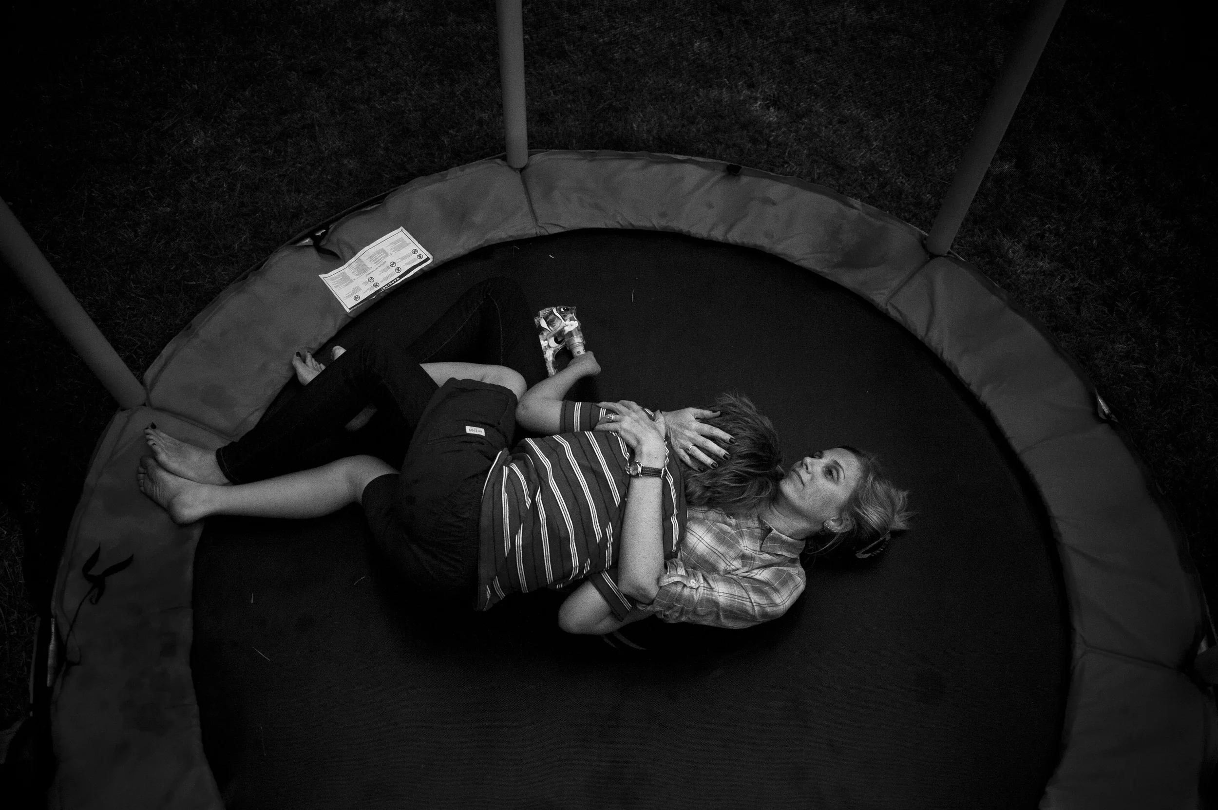  Erin O'Loughlin embraces her son Brendan O'Loughlin after his brother Marcus O'Loughlin, who has autism, attacked him while they were playing on the trampoline outside the family's home in Cary, NC on October 6, 2014.  As Marcus has aged, the frustr
