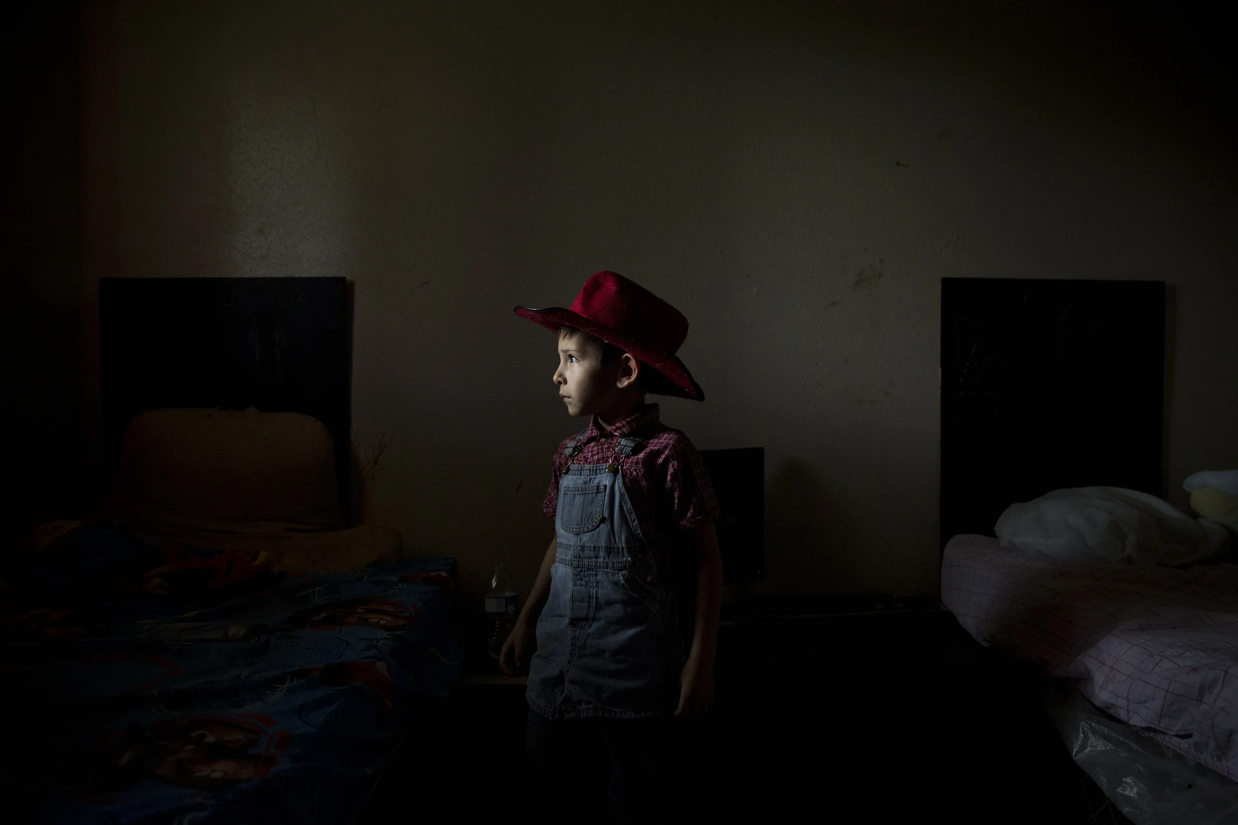  Caiden Contreras, who has autism, stands for a portrait in the room he shares with three of his brothers at his home in San Antonio, Texas on May 27, 2015.  His parents are both unemployed and living off of his and some of his siblings' disability c