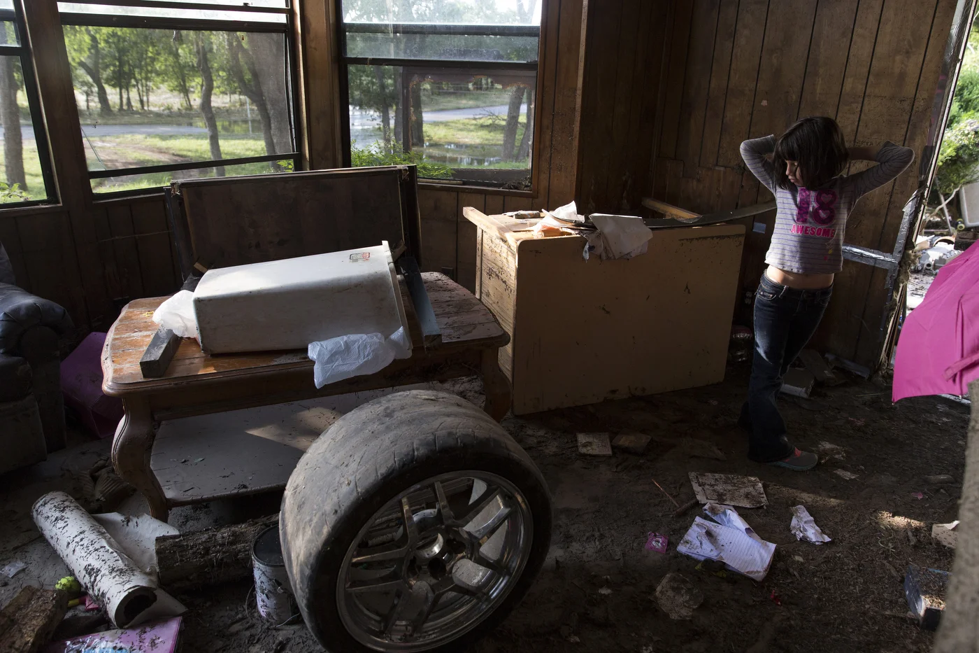  Serenity Bamberger, 7, looks at the damage in her home in Blanco, Texas on Friday, May 29, 2015. Of the donations that have flooded in to help Serenity and her family, she said, "It is like Christmas." However, her mother Glenda Bamberger said that 