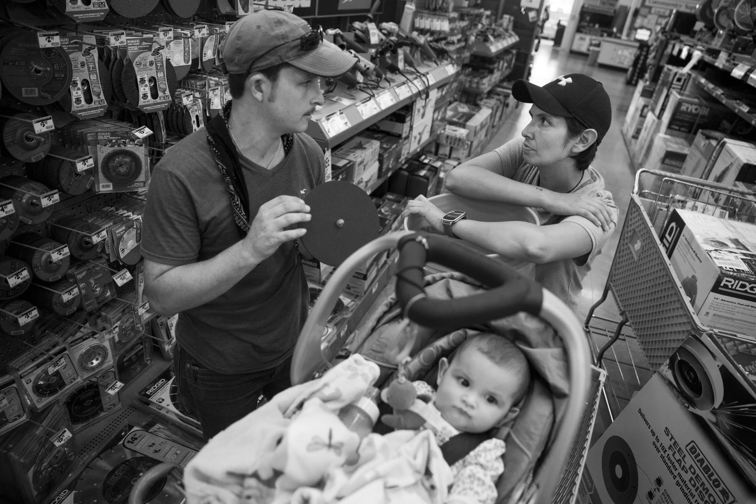  Jarrell Bamberger talks to his wife Glenda Bamberger about what they need to start building their home while their daughter Esme Bella, 9 months, sits in their shopping cart at Home Depot in Bulverde, Texas on July 10, 2015. They began construction 