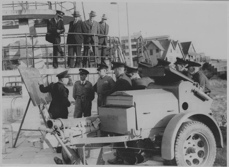 Saltdean Lido played its part during World War II. From October 1941, the National Fire Service used the main pool as a water storage tank and for training exercises. Here, fire officers are receiving instruction at the base of the lido's three tiered diving boards.