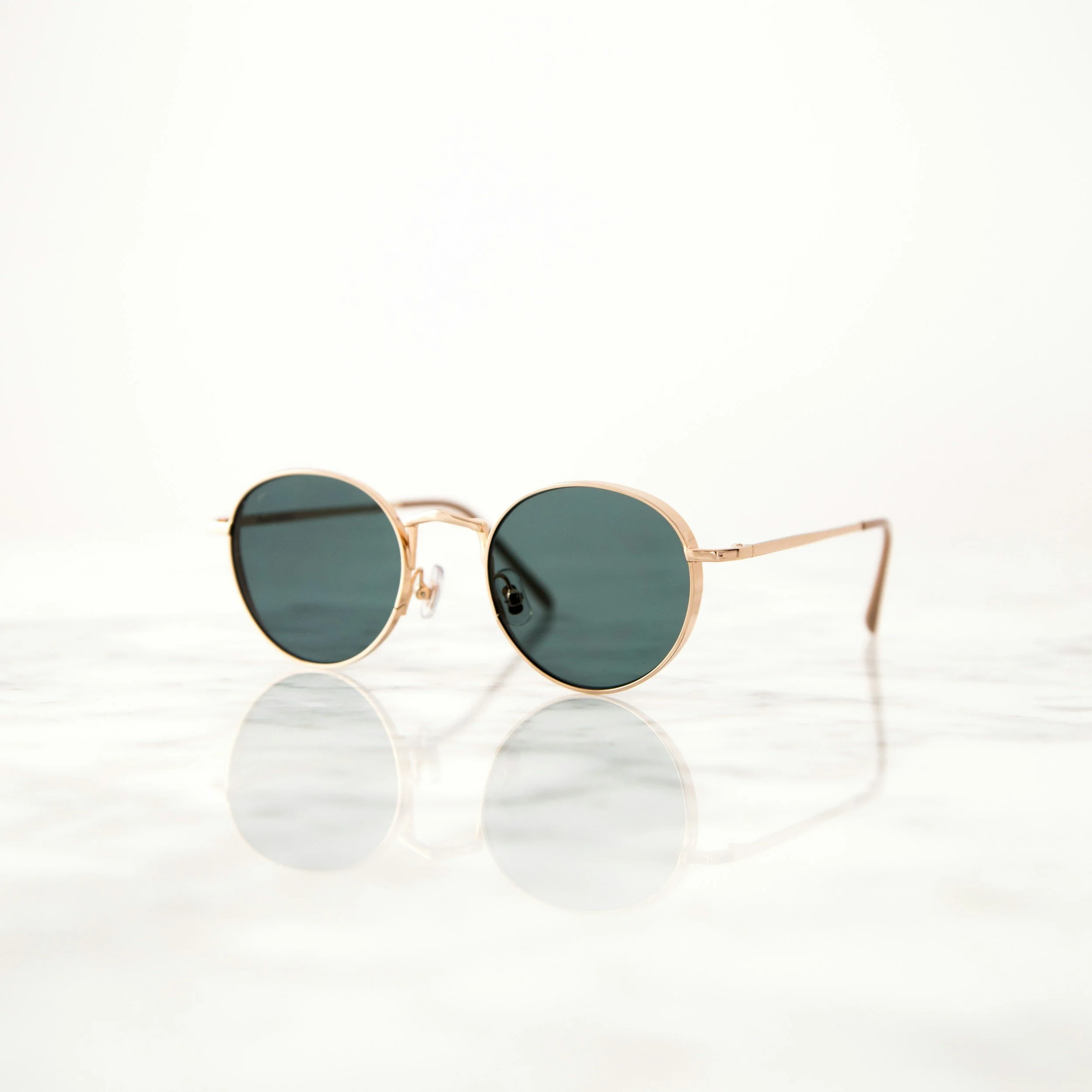 Round sunglasses on a light surface