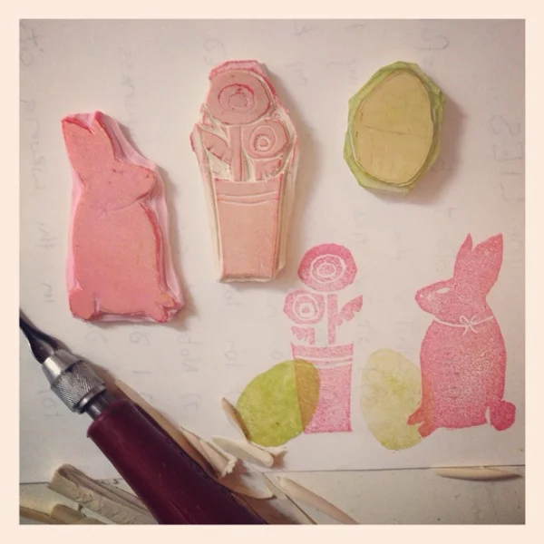 hand carved stamps on stamping material (the pink is the best) and firm drafting erasers 