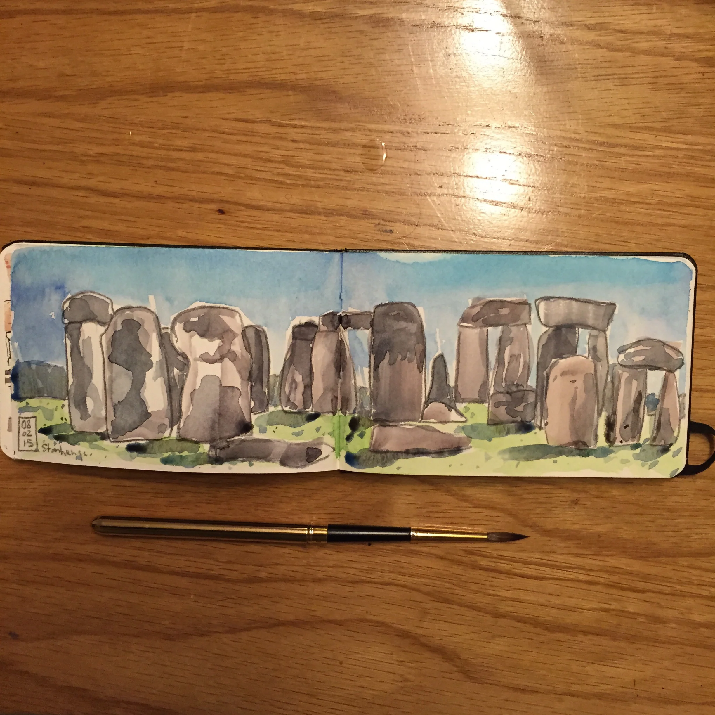 Stonehenge sketch. Watercolor and grey colored pencil in a pocket moleskine watercolor book.