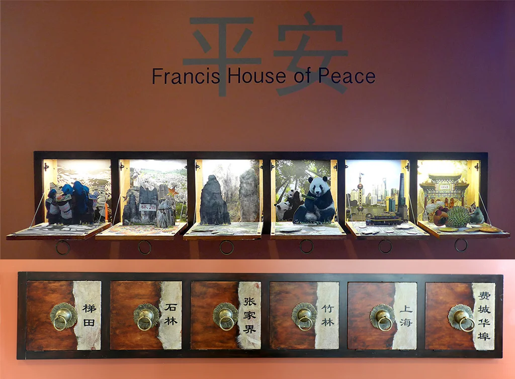 Pull on the Sun Pull handle and the door drops down and reveals a pop-up scene. The pulls represent the strength and brilliance of the sun, to complement the outside moon imagery. Five pop-up apothecary drawers represent different idyllic landscapes in China that represent Home, and the final drawer features foods from different regions of China that can be found in our own Chinatown.