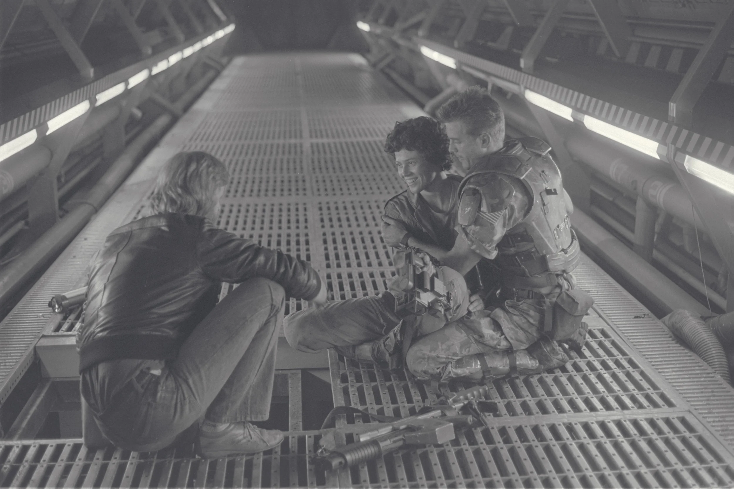 Writer/director James Cameron with Sigourney Weaver and Michael Biehn on the Pinewood Studios set of ALIENS circa 1985. (Fox)