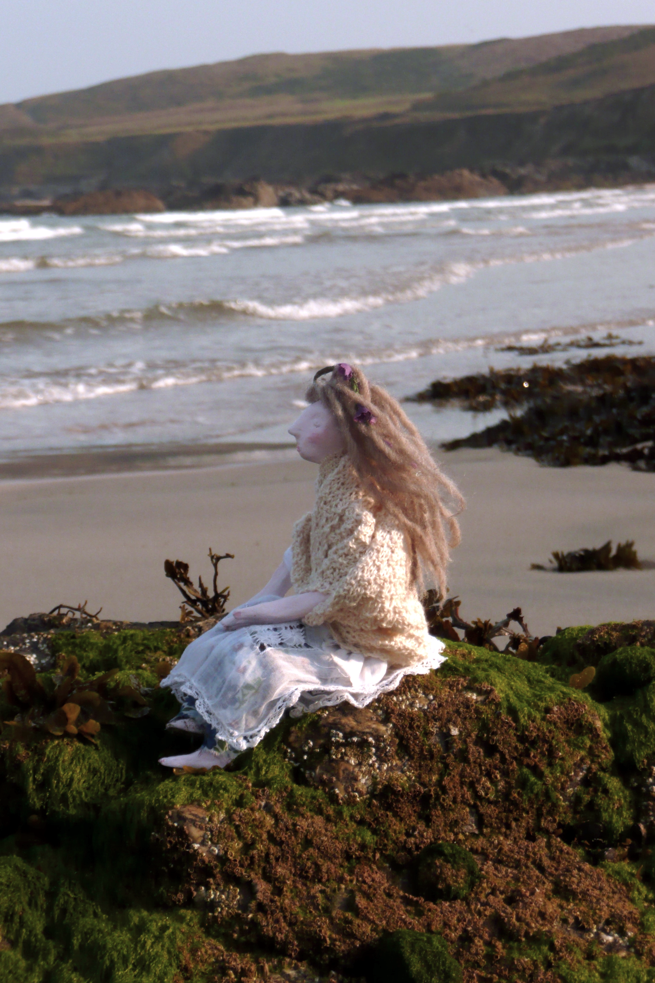 The Sea and me; Doll on rock by Claire Blackburn