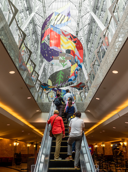   Tepkik, 2018    Materials:  Print on Polysilk, 3M reflective print on Aluminum panels  Dimensions:  100'x40'x25’  Photo:  Ernesto Di Stefano  Installation commissioned by Brookfield Place Toronto.  Produced by Pearl Wagner Art Consultants.  Project