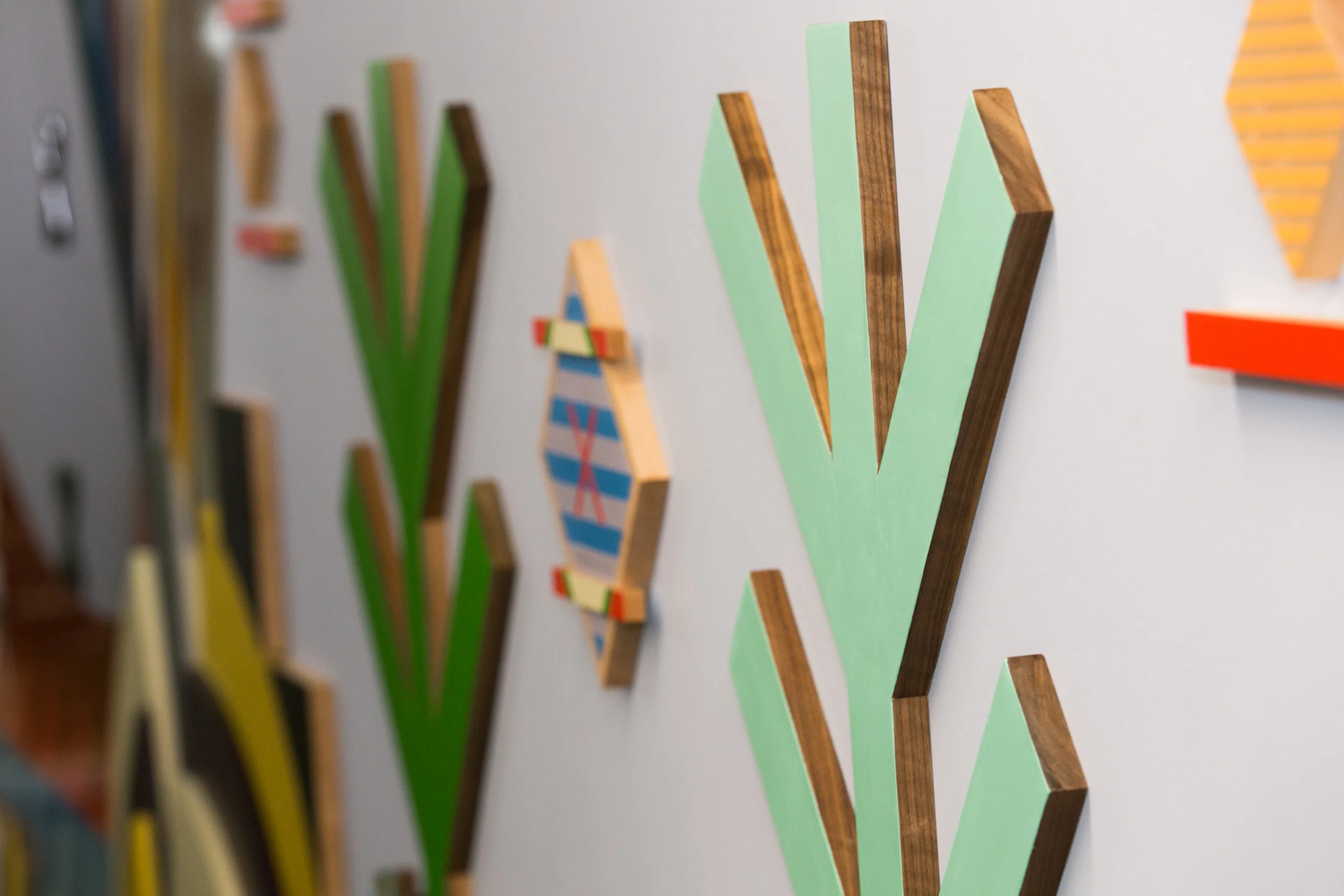 Pjila'si, 2019 Zatzman Sportsplex , Dartmouth Materials: Oak, walnut, maple, Labradorite, steel, acrylic paint, ash, plexiglass, 3M reflective print on Aluminum panels Dimensions: 35’x10’x2’ Photo: Chantal Routhier Installation commissioned by City of Halifax Regional Municipality Project managed by IOTA STUDIOS