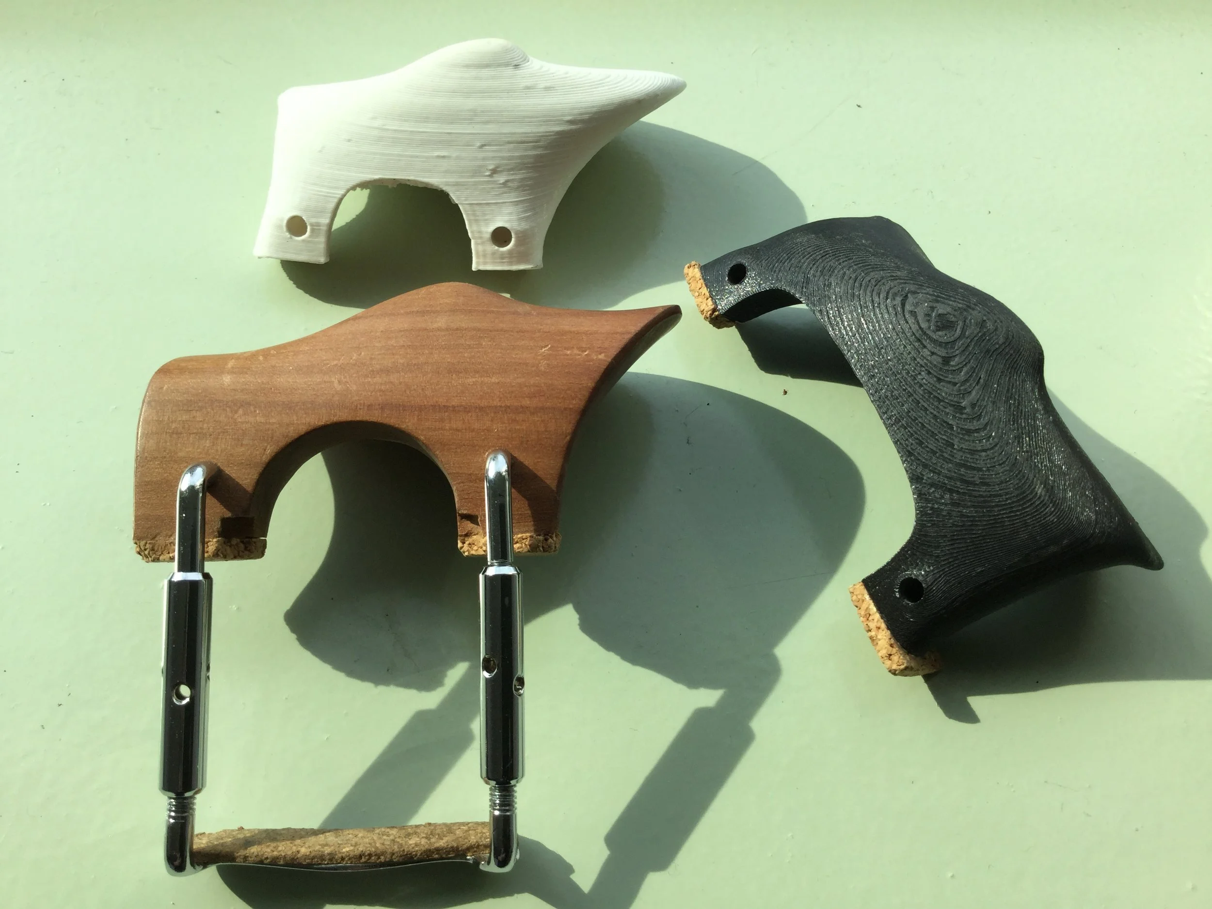 After careful measuring of individual players, custom chin rests are printed using 3D printing techniques. This allows players to try out the design and change it as needed for the next re-print. Final chin rests can then be printed in PLA or created in wood from the digital design.