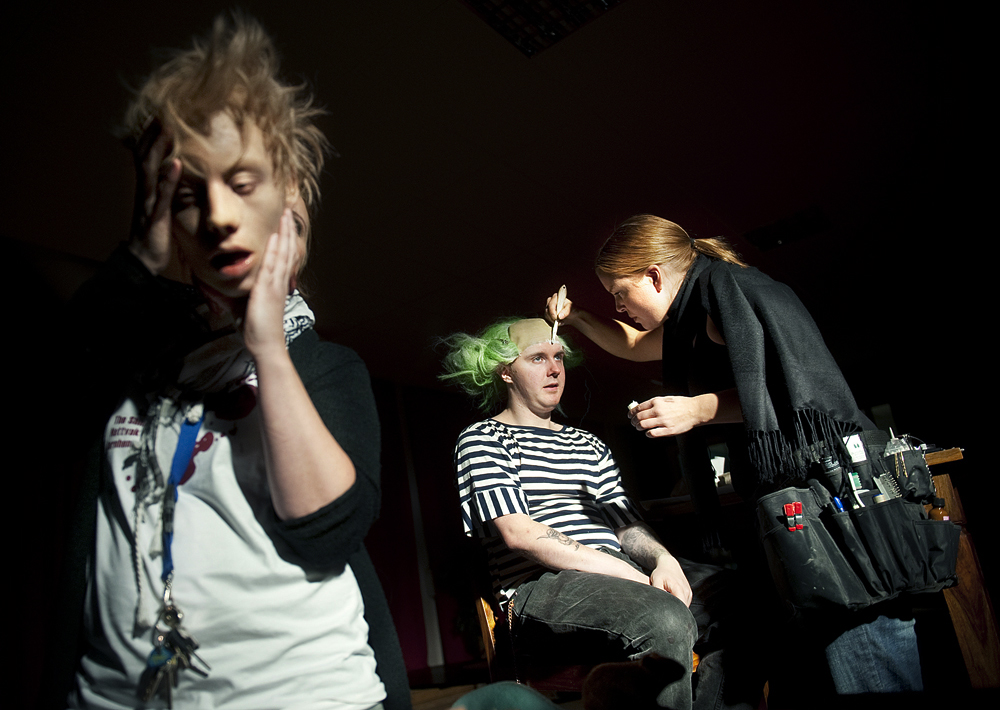 Theatrical makeup artist working. 