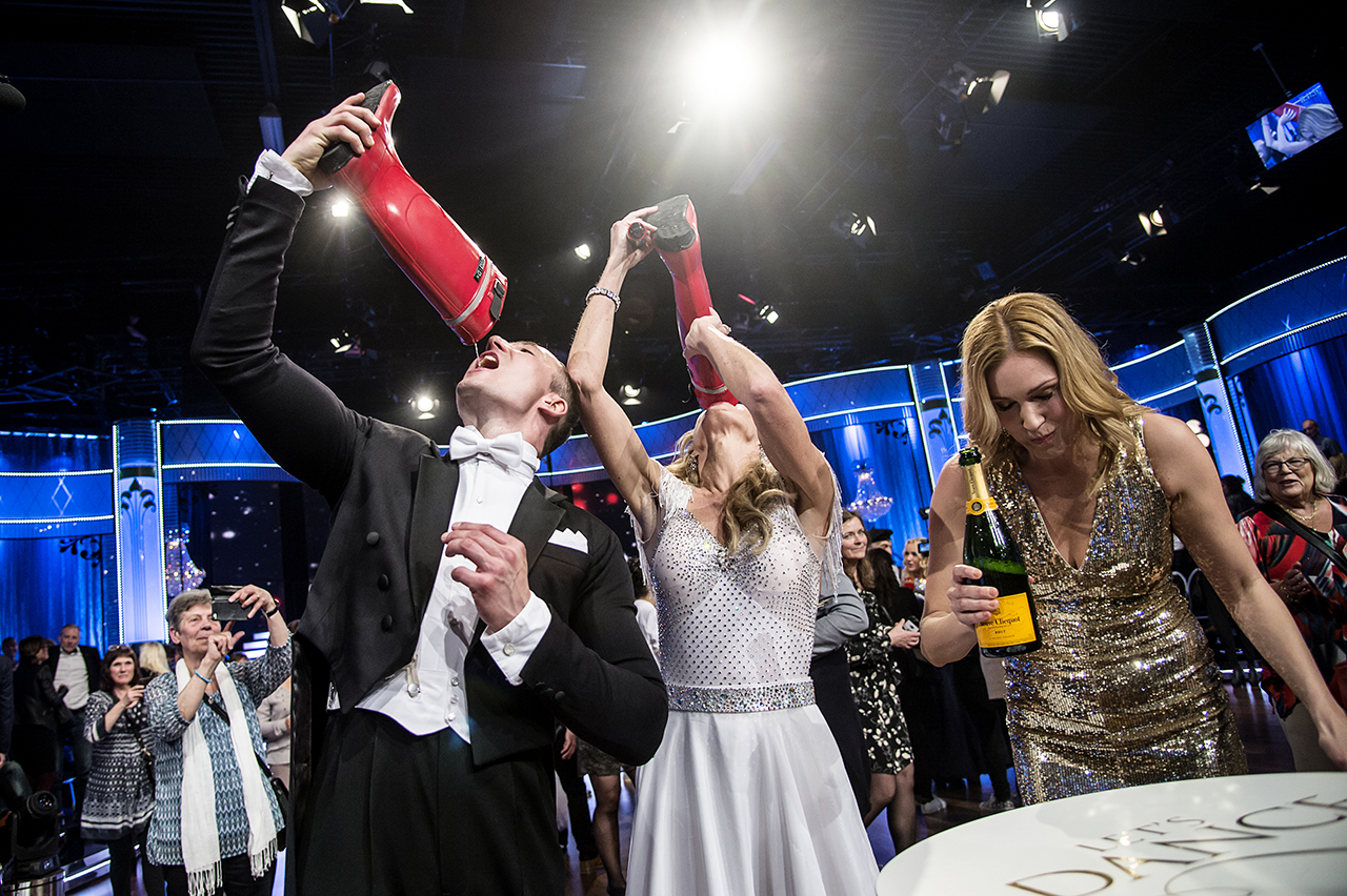 Linda Lindorff and her dance partner Kristjan Lootus drinking champagne out of boots after a program of Let´s Dance. 