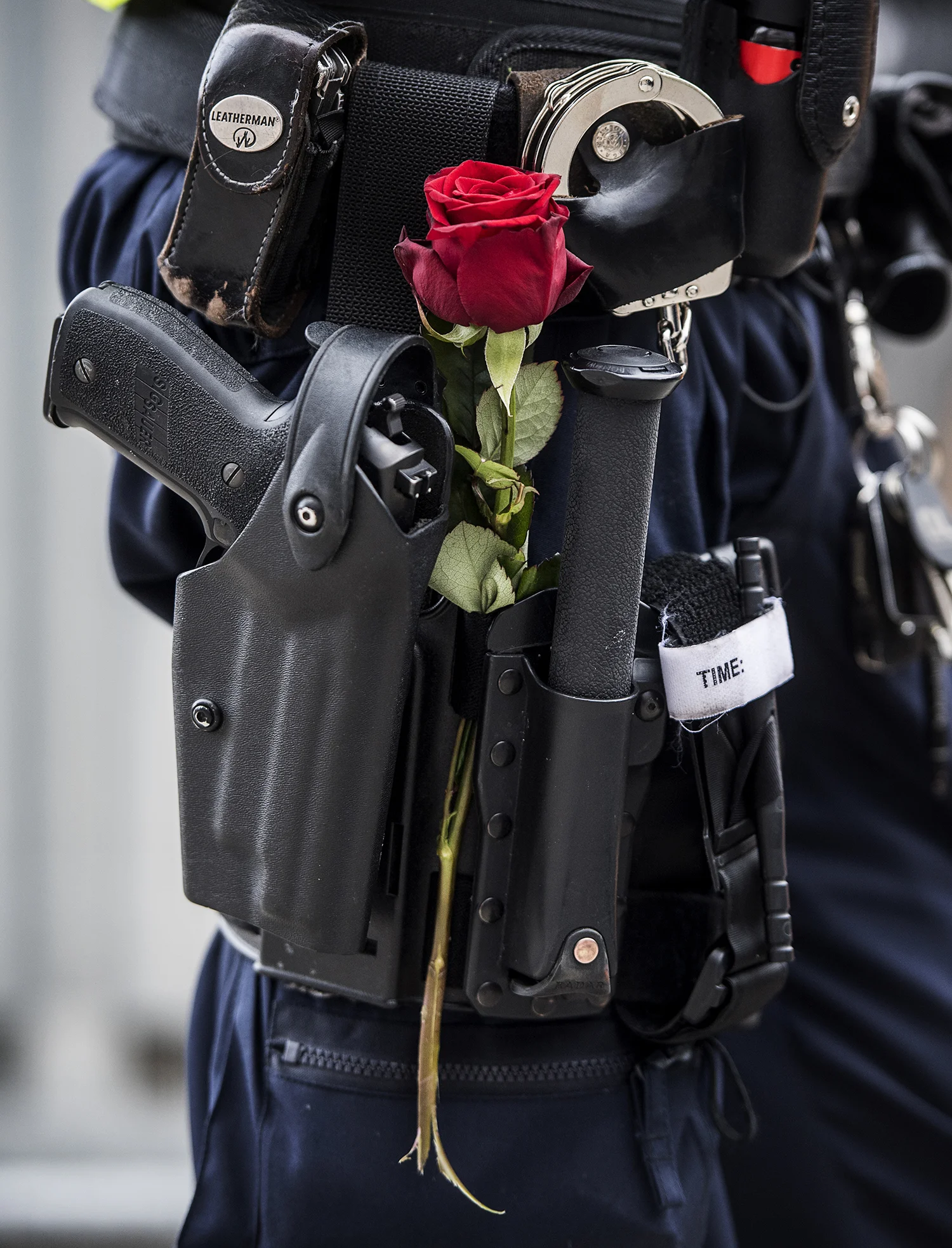  One day after the terror attack at Drottninggatan. Rose next to a policeman's gun 