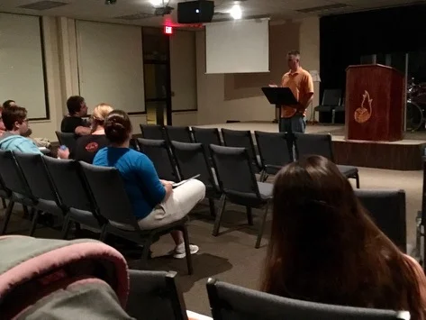 Adam McFeaters leads a bible study during the all-night prayer meeting.