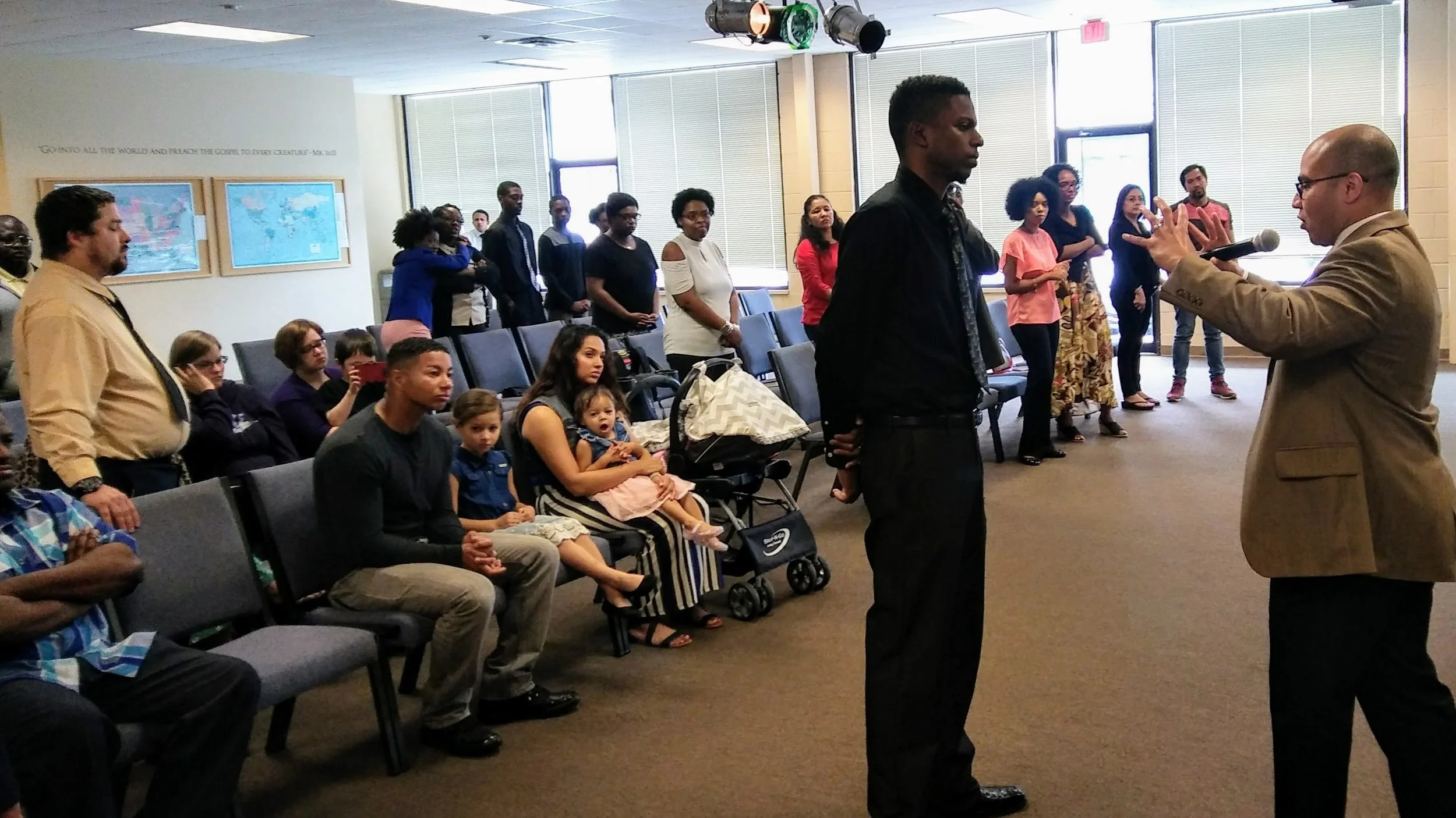 Christopher Lee receives a word from Pastor Eric Pizzaro in a recent service.