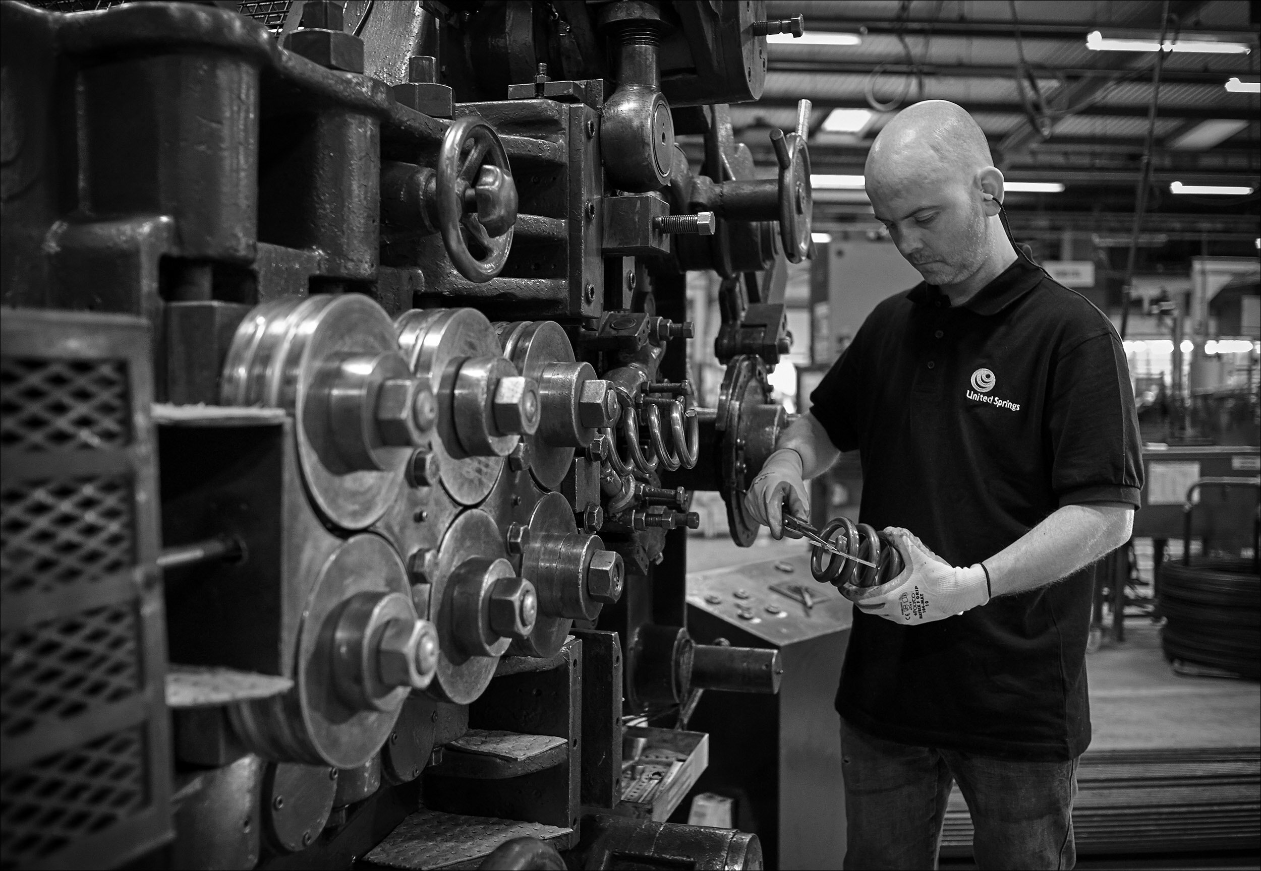 Engineer measuring spring gauge in spring manufacturing factory