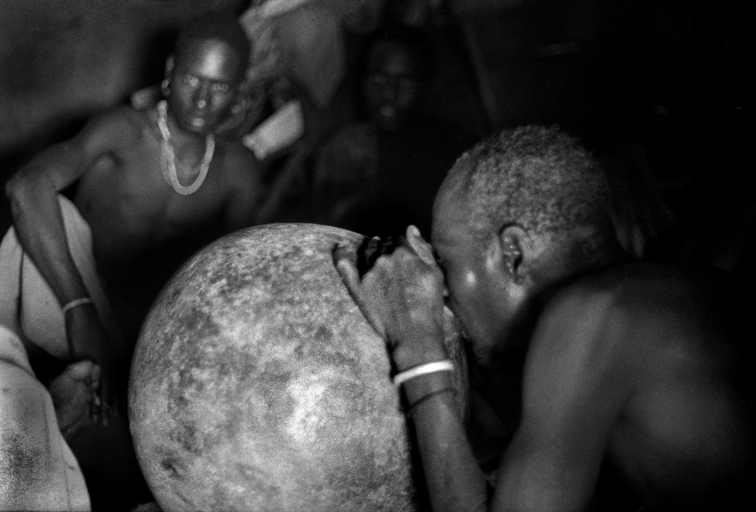 Karamojong warriors drinking sorghum beer, Uganda