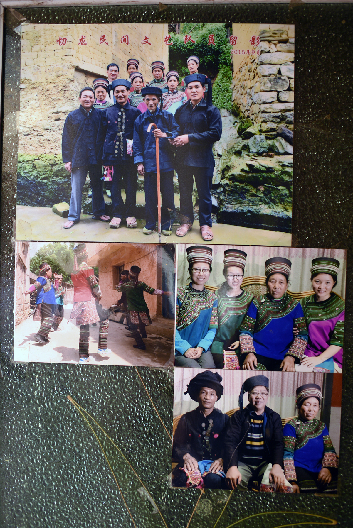  Photographs on the doorway of home of Che Kasan reveal long family history of involvement with musical intangible cultural heritage. &nbsp; Qielong village, Yunnan, 2017. 